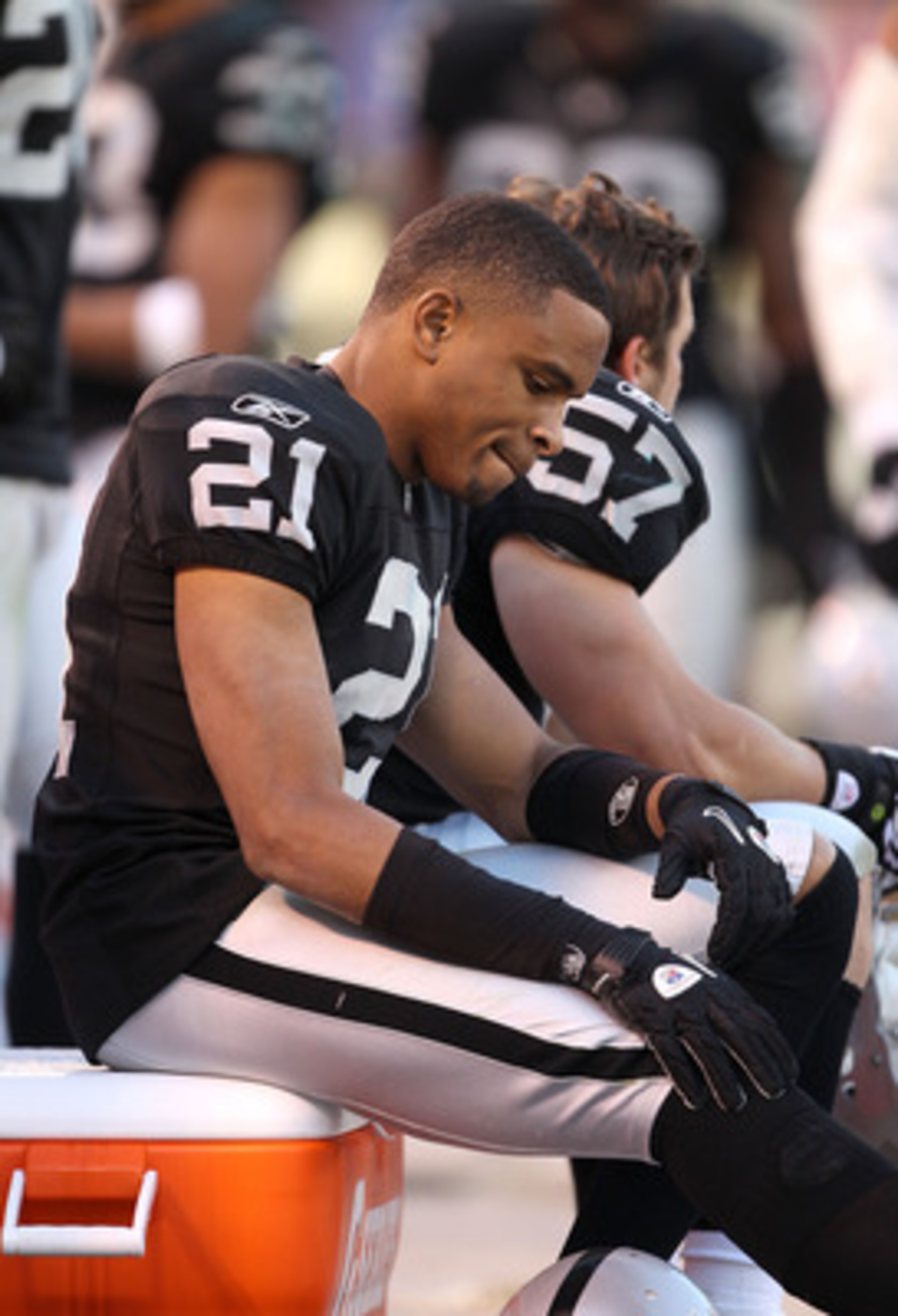 OAKLAND, CA - NOVEMBER 28:  Nnamdi Asomugha #21 of the Oakland Raiders sits on the bench during the closing minutes of their loss to the Miami Dolphins at Oakland-Alameda County Coliseum on November 28, 2010 in Oakland, California.  (Photo by Ezra Shaw/Ge