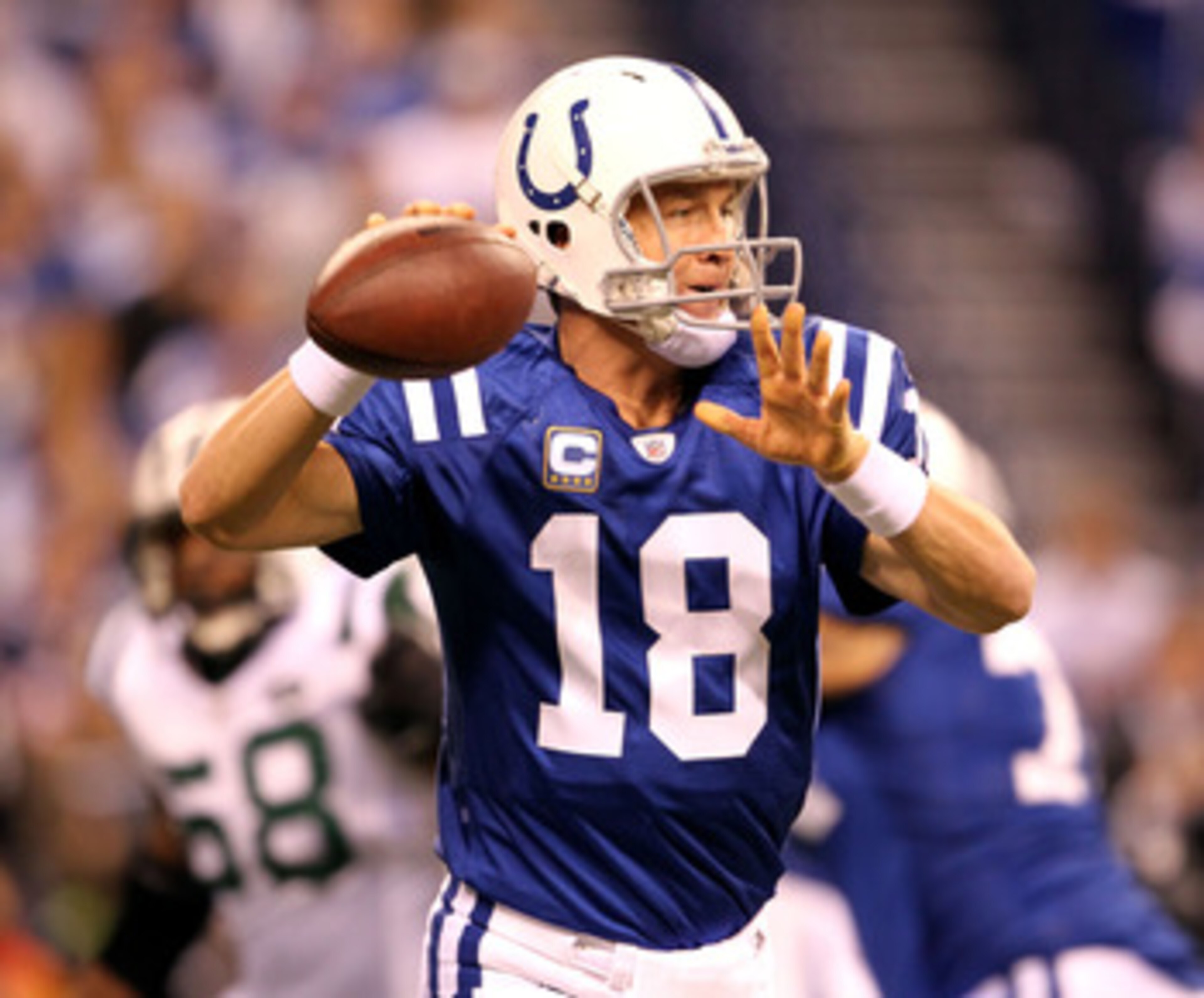 INDIANAPOLIS, IN - JANUARY 08:  Quarterback Peyton Manning #18 of the Indianapolis Colts passes the ball in the first quarter against the New York Jets during their 2011 AFC wild card playoff game at Lucas Oil Stadium on January 8, 2011 in Indianapolis, I
