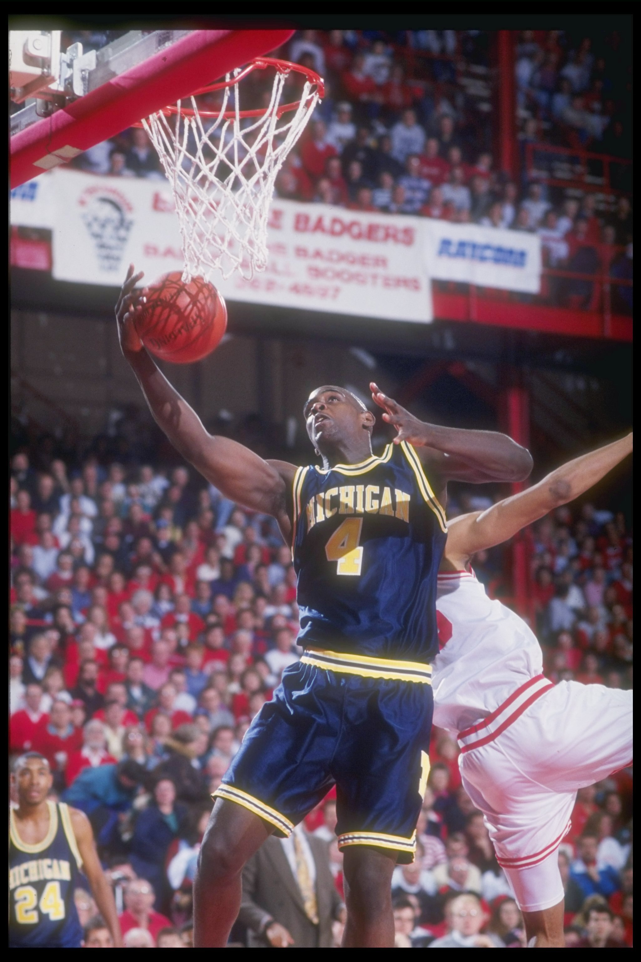 9 Jan 1993: MICHIGAN FORWARD CHRIS WEBBER GRABS A REBOUND WHILE BATTLING A WISCONSIN PLAYER DURING THE WOLVERINES GAME VERSUS THE BADGERS AT WISCONSIN FIELD HOUSE IN MADISON, WISCONSIN.