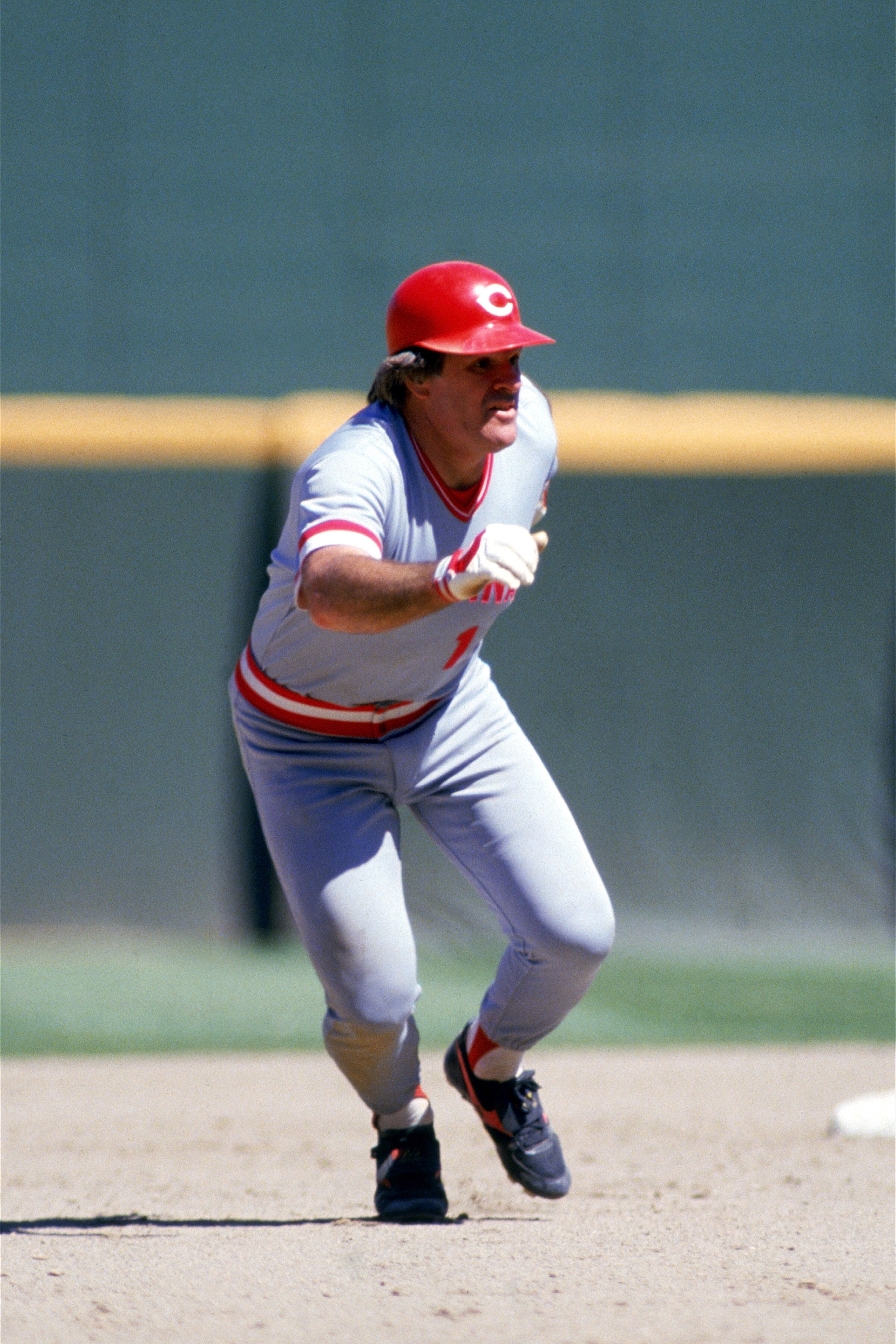 SAN DIEGO, CA - 1986:  Pete Rose #14 of the Cincinnati Reds runs between bases during a game against the San Diego Padres at Jack Murphy Stadium in the 1986 MLB season in San Diego, California.  (Photo by Stephen Dunn/Getty Images)