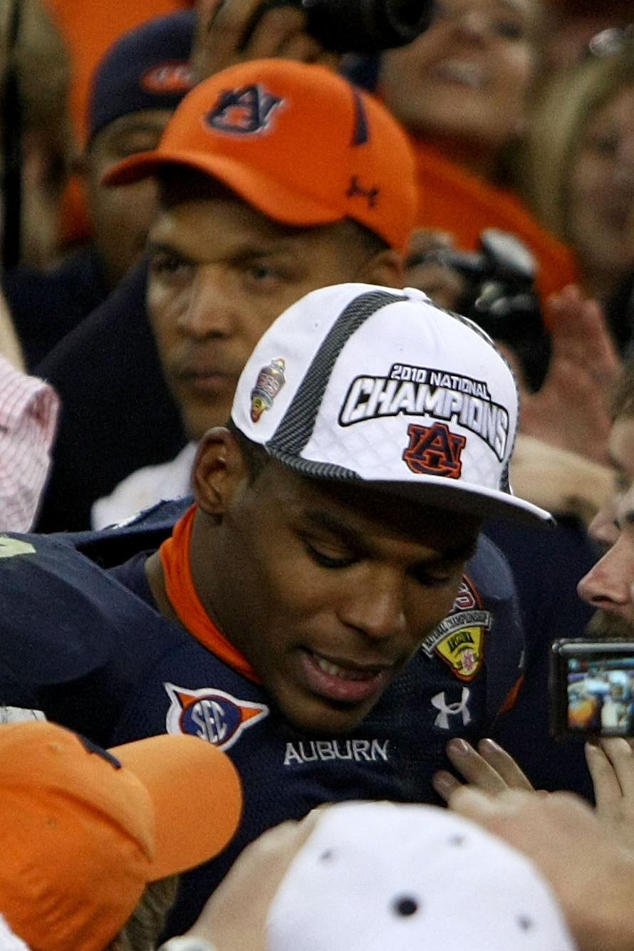 GLENDALE, AZ - JANUARY 10:  Quarterback Cameron Newton #2 of the Auburn Tigers celebrates as his father Cecil Newton is behind him after the Tigers 22-19 victory against the Oregon Ducks in the Tostitos BCS National Championship Game at University of Phoe