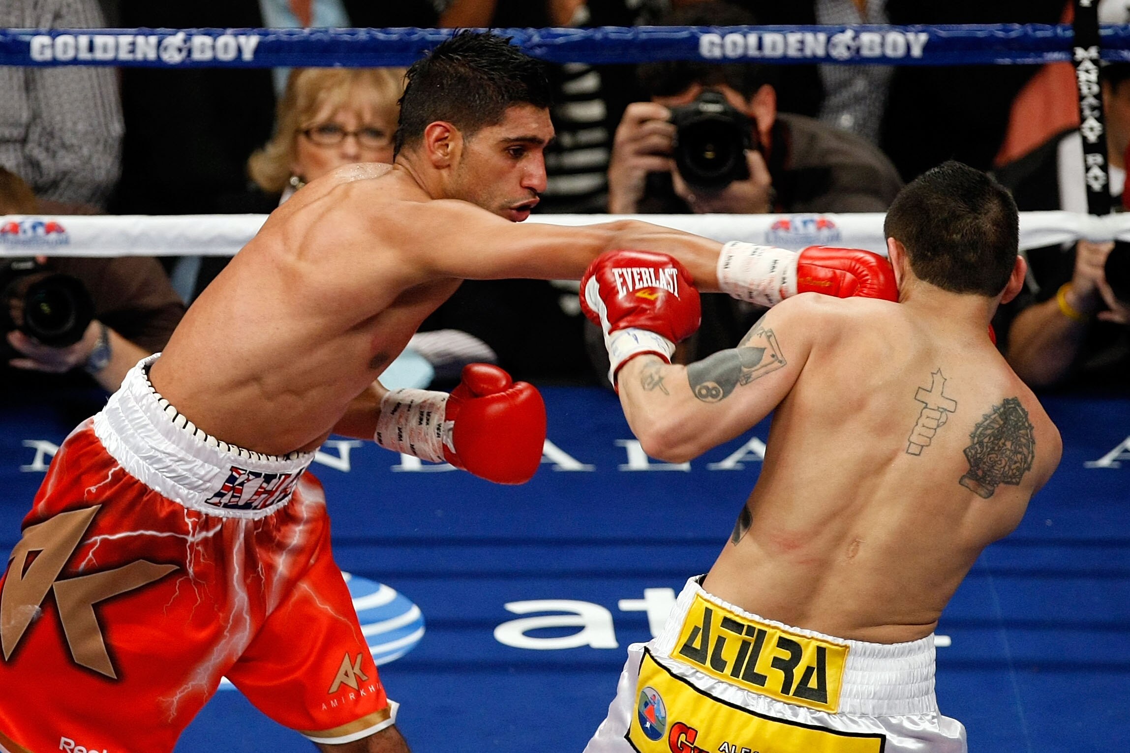 LAS VEGAS - DECEMBER 11:  (L-R) Amir Khan of England connects with a right to the face of Marcos Maidana of Argentina during the WBA super lightweight title fight at Mandalay Bay Events Center on December 11, 2010 in Las Vegas, Nevada.  (Photo by Ethan Mi