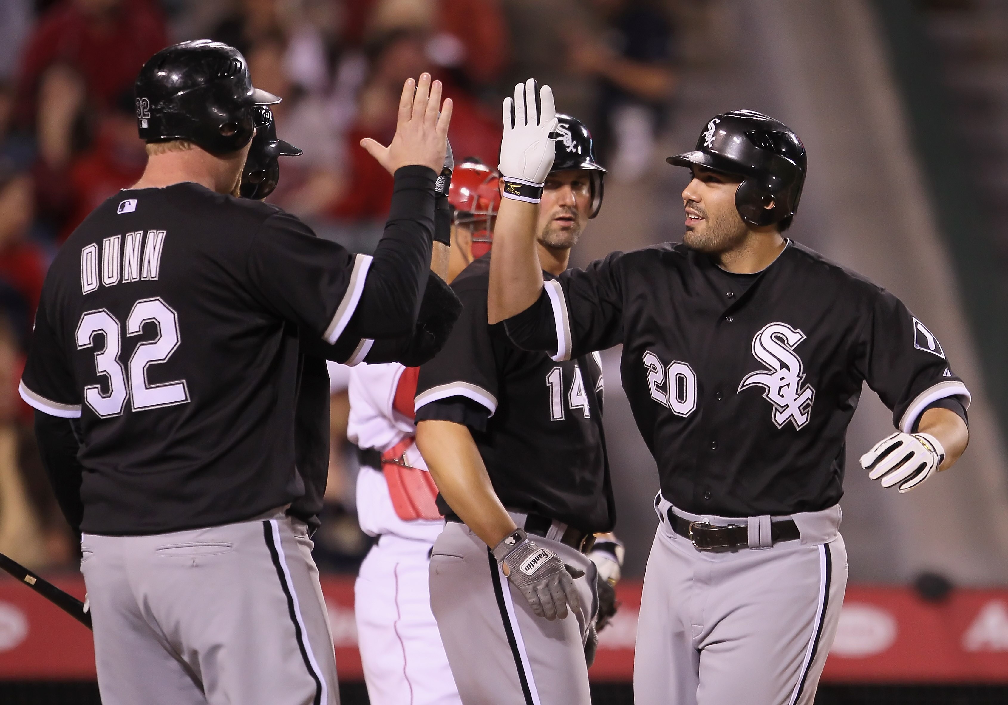 ANAHEIM, CA - MAY 09:  Carlos Quentin #20 and Adam Dunn #32 of the Chicago White Sox celebrate Quentin's three-run home run against the Los Angeles Angels of Anaheim in the seventh inning at Angel Stadium of Anaheim on May 9, 2011 in Anaheim, California.