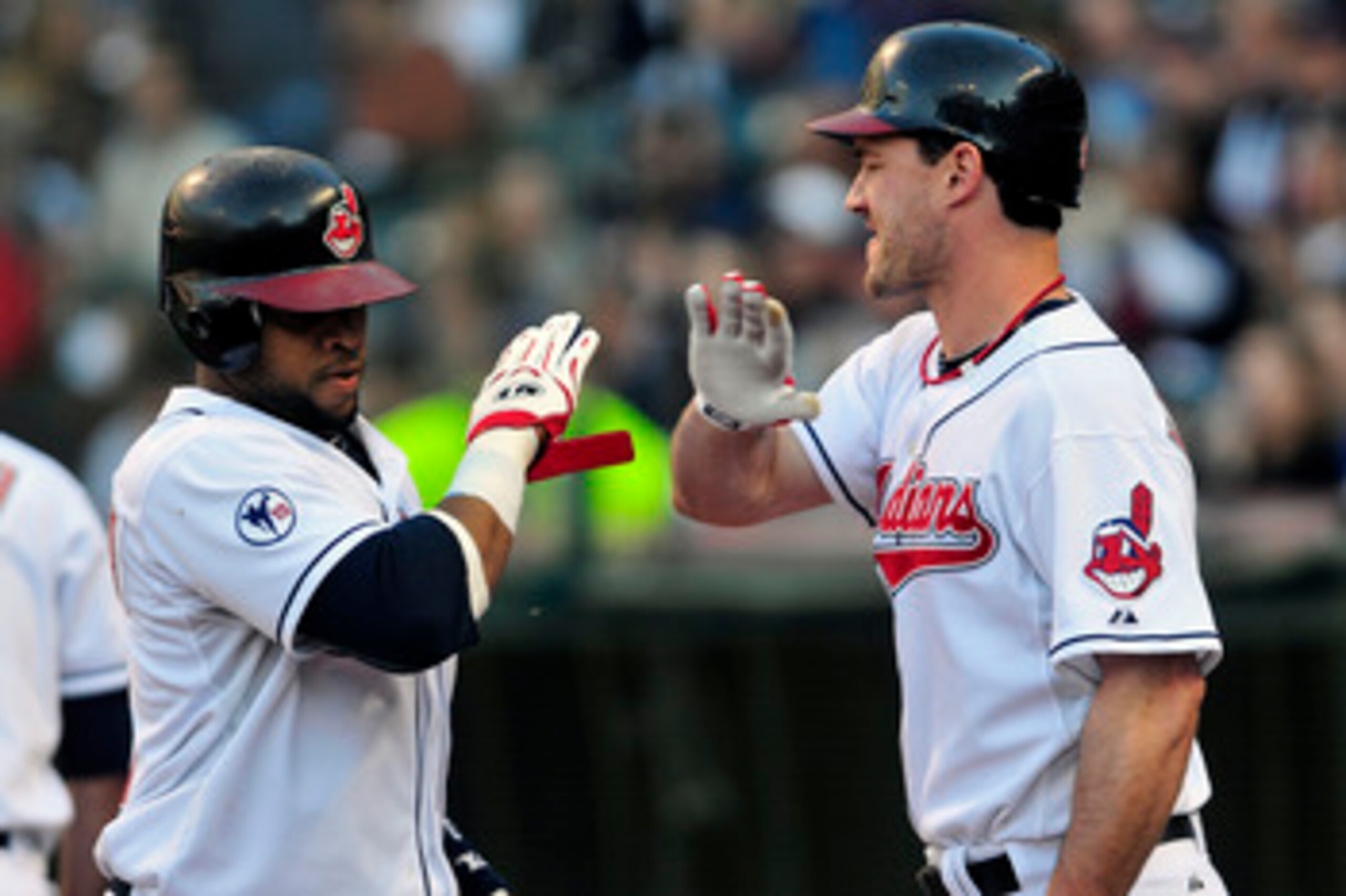 CLEVELAND, OH - JUNE 2:   Carlos Santana #41 of the Cleveland Indians celebrates with Jack Hannahan #9 after Santana was driven home off a hit from Travis Buck #28 (not shown) during the second inning against the Texas Rangers at Progressive Field on June