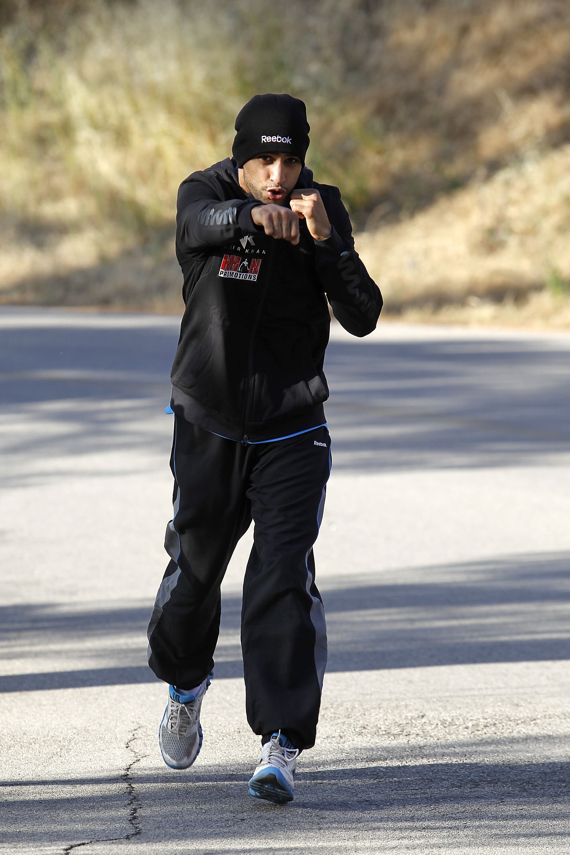 LOS ANGELES, CA - MAY 25:  Amir Khan runs in the Hollywood Hills wearing Reebok ZigTech apparel and footwear at Griffith Park on May 25, 2011 in Los Angeles, California. The light-welterweight World Champion began training this week in Los Angeles for his
