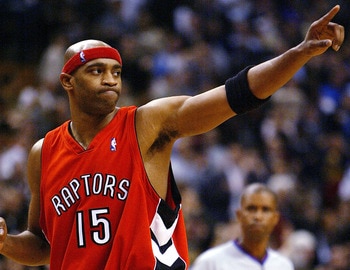 TORONTO - NOVEMBER 3:   Vince Carter #15 of the Toronto Raptors salutes the crowd after beating the Houston Rockets 95-88 during a game at the Air Canada Centre on November 3, 2003 in Toronto, Canada.  NOTE TO USER: User expressly acknowledges and agrees 