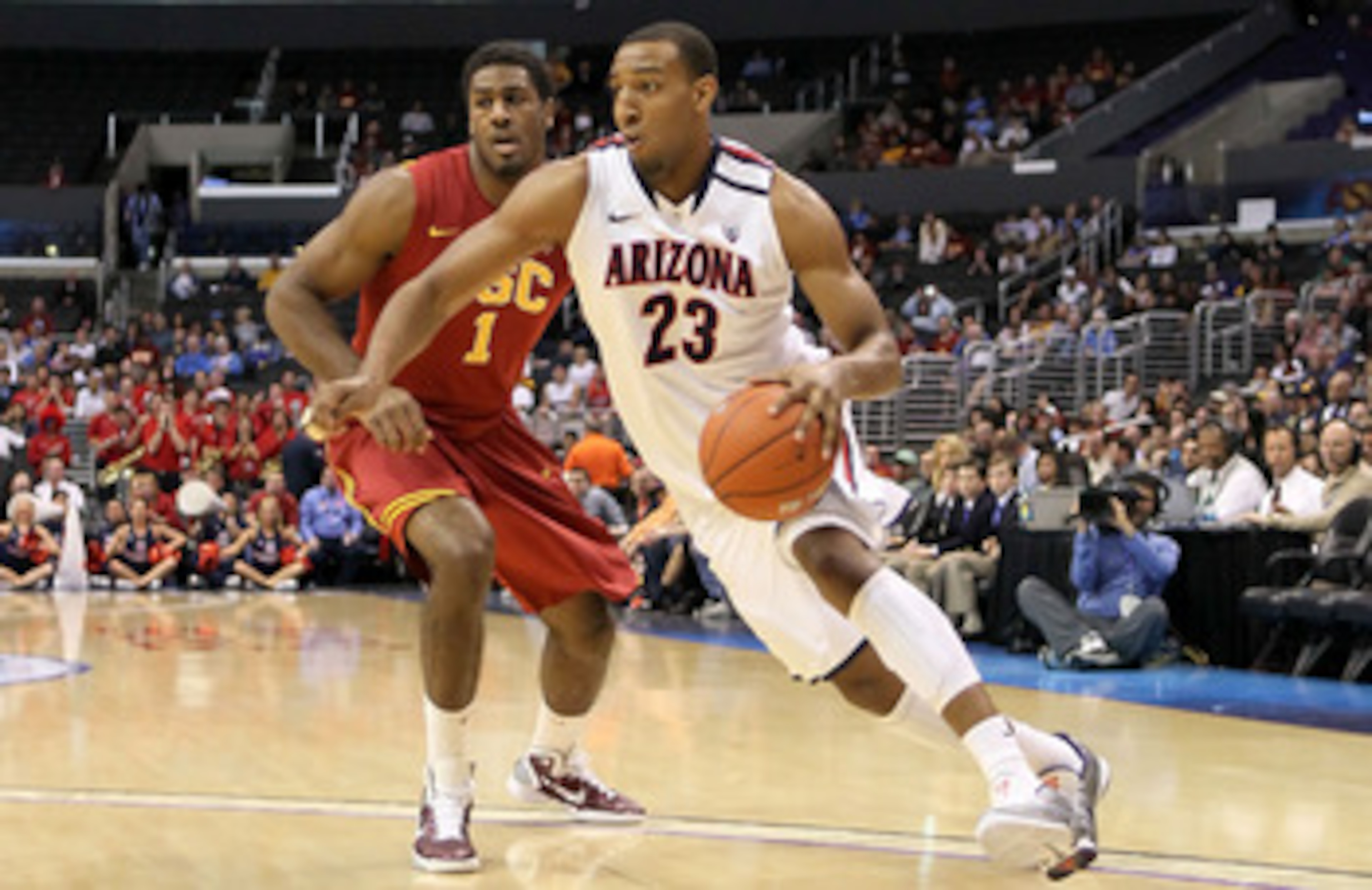 LOS ANGELES, CA - MARCH 11:  Derrick Williams #23 of the Arizona Wildcats drives on Alex Stepheson #1 of the USC Trojans in the first half in the semifinals of the 2011 Pacific Life Pac-10 Men's Basketball Tournament at Staples Center on March 11, 2011 in