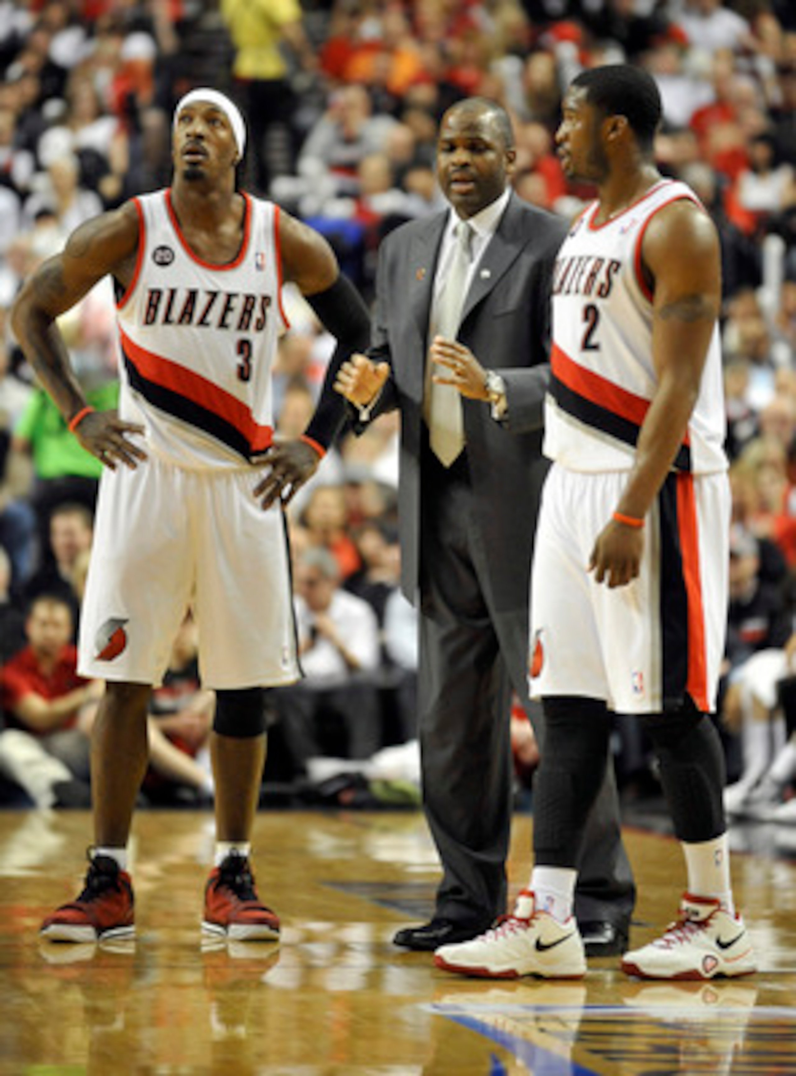 PORTLAND, OR - APRIL 28: (L to R) Gerald Wallace #3, head coach Nate McMillan and Wes Matthews #2 of the Portland Trail Blazers gather during a time out in the fourth quarter of Game Six of the Western Conference Quartefinals in the 2011 NBA Playsoffs on 