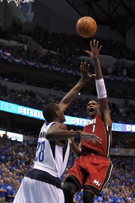DALLAS, TX - JUNE 05:  Chris Bosh #1 of the Miami Heat attempts a shot against Ian Mahinmi #28 of the Dallas Mavericks in Game Three of the 2011 NBA Finals at American Airlines Center on June 5, 2011 in Dallas, Texas.  NOTE TO USER: User expressly acknowl