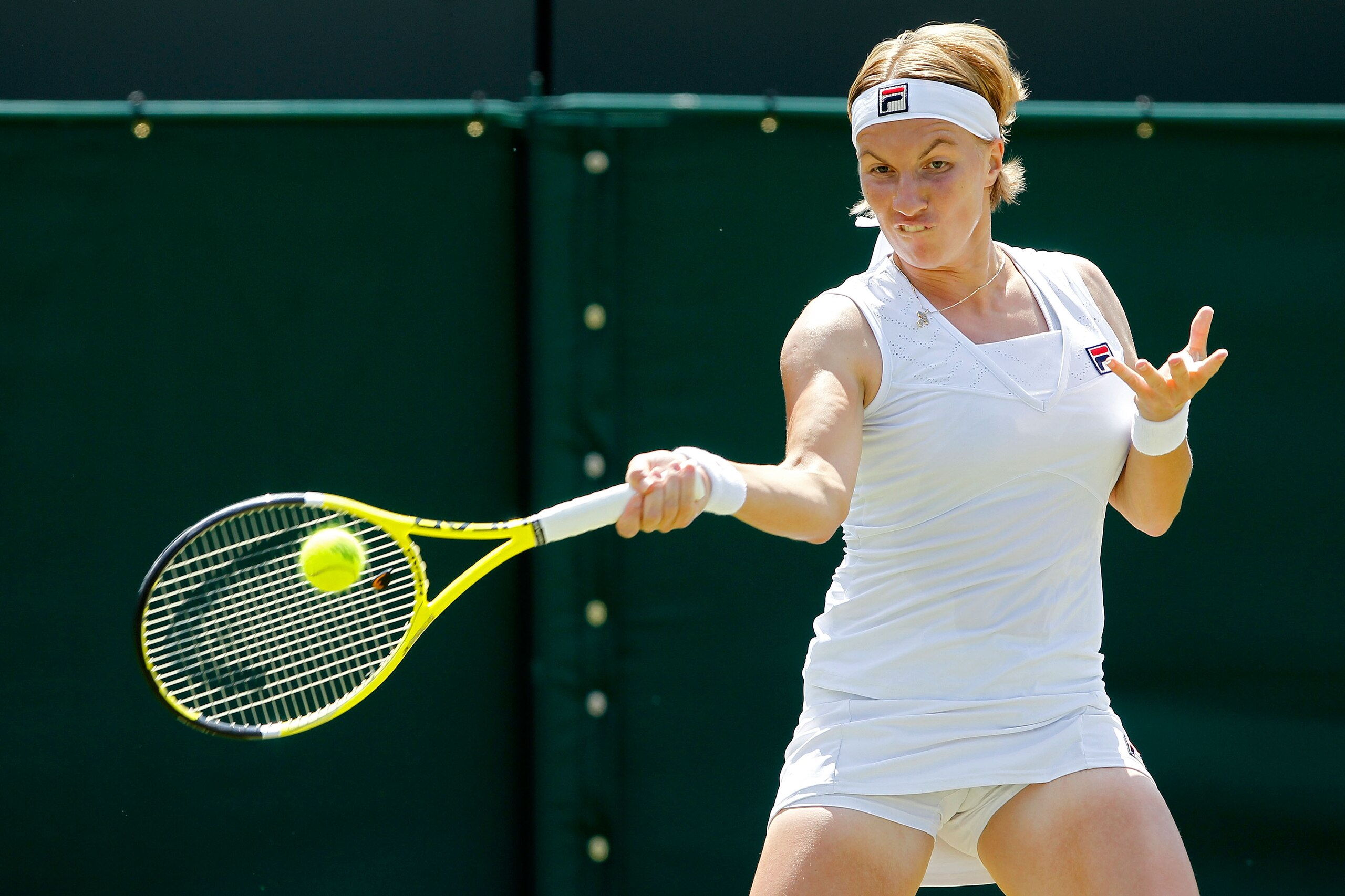 LONDON, ENGLAND - JUNE 22:  Svetlana Kuznetsova of Russia in action during her first round match against Akgul Amanmuradova of Uzbekistan on Day Two of the Wimbledon Lawn Tennis Championships at the All England Lawn Tennis and Croquet Club on June 22, 201