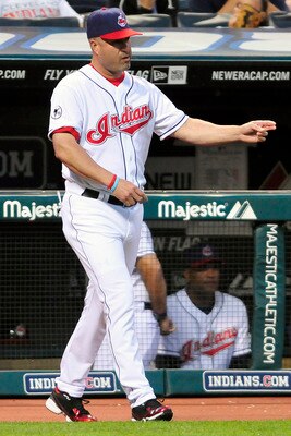 CLEVELAND, OH - JUNE 3: Manny Acta #11 of the Cleveland Indians calls to the bullpen to replace starting pitcher Justin Masterson #63 (not shown) during the sixth inning against the Texas Rangers at Progressive Field on June 3, 2011 in Cleveland, Ohio.  (