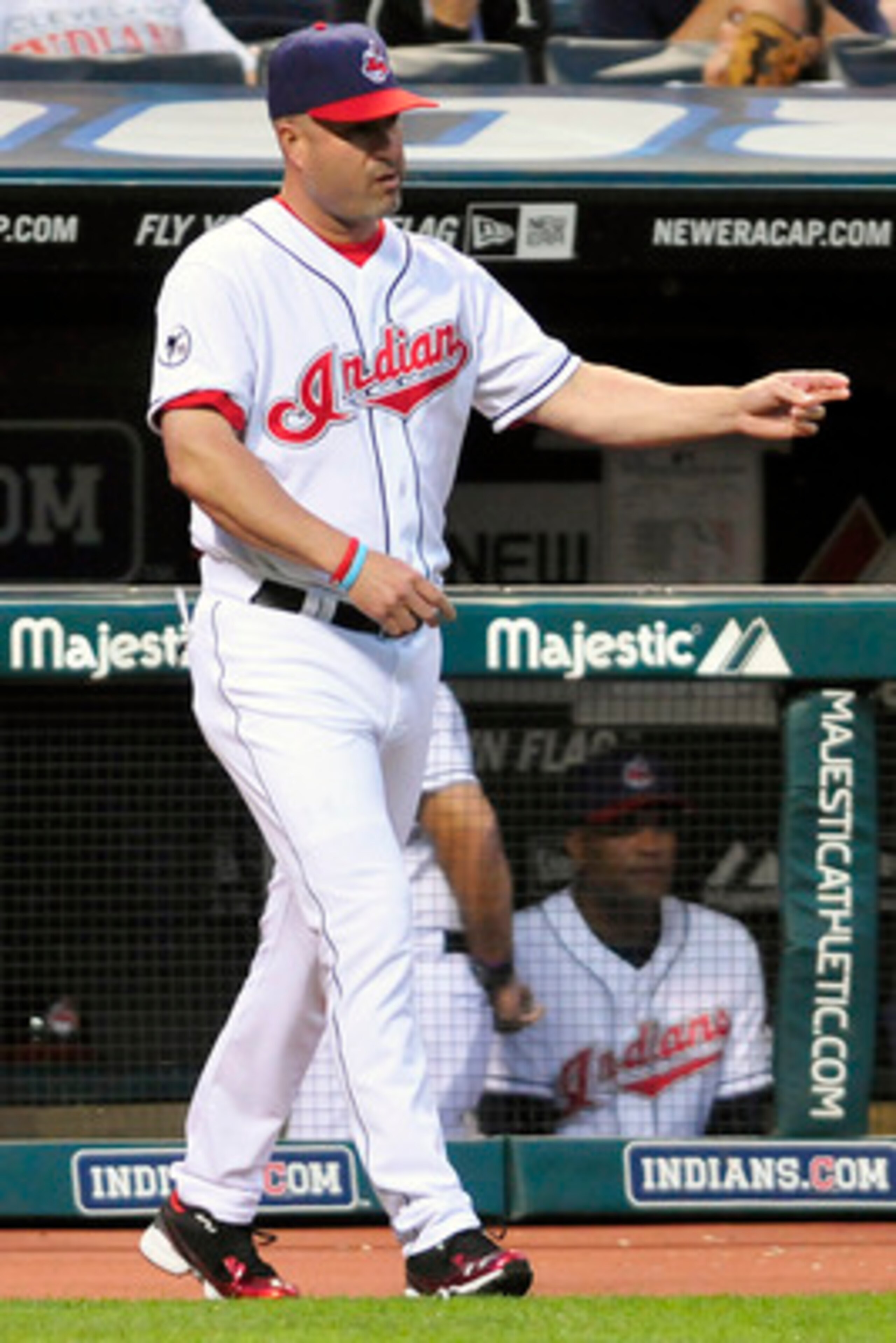 CLEVELAND, OH - JUNE 3: Manny Acta #11 of the Cleveland Indians calls to the bullpen to replace starting pitcher Justin Masterson #63 (not shown) during the sixth inning against the Texas Rangers at Progressive Field on June 3, 2011 in Cleveland, Ohio.  (