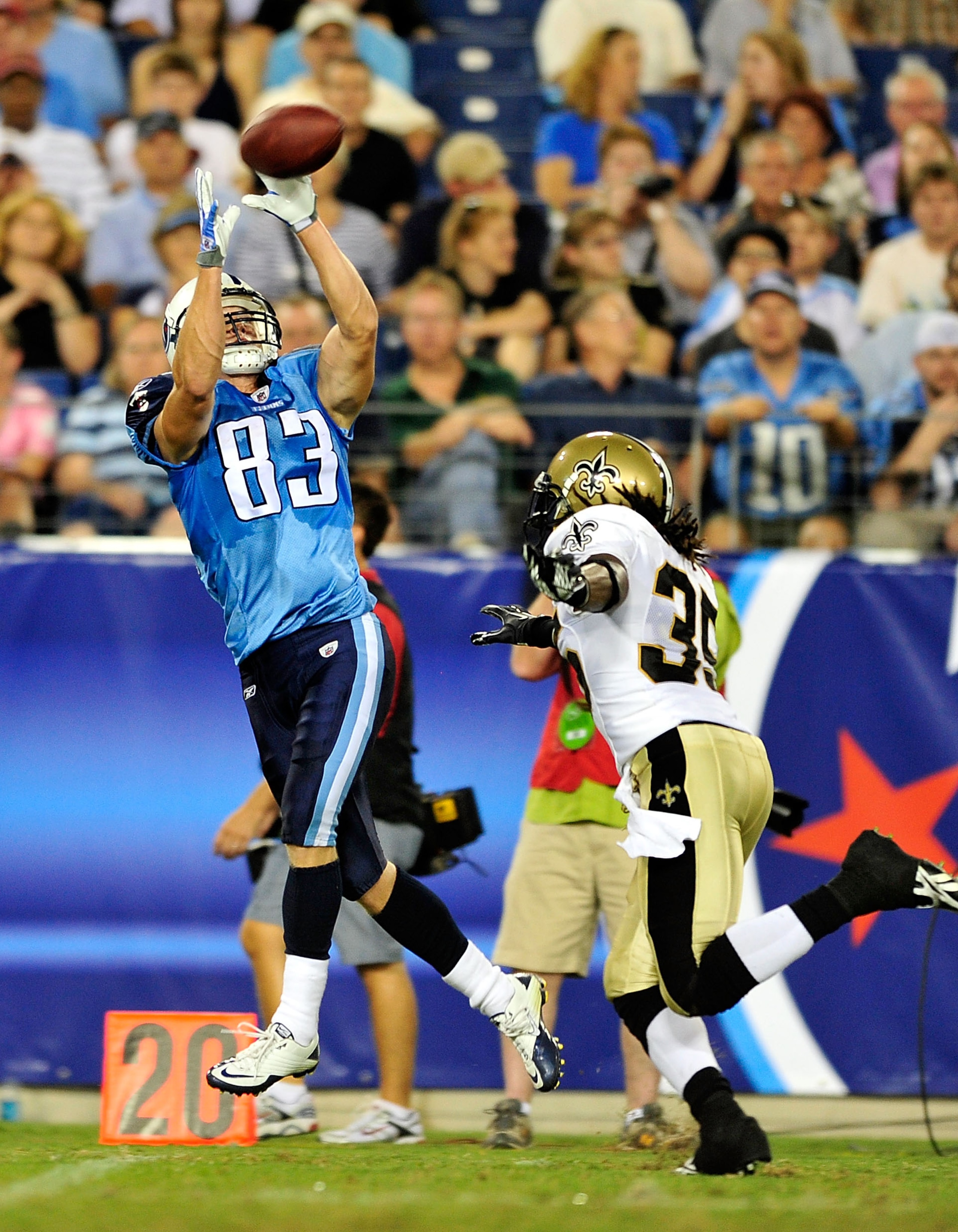 NASHVILLE, TN - SEPTEMBER 02:  Marc Mariani #83 of the Tennessee Titans makes a catch as Reggie Jones #35 of the New Orleans Saints defends during an exhibition game at LP Field on September 2, 2010 in Nashville, Tennessee. Tennessee won 27-24.  (Photo by