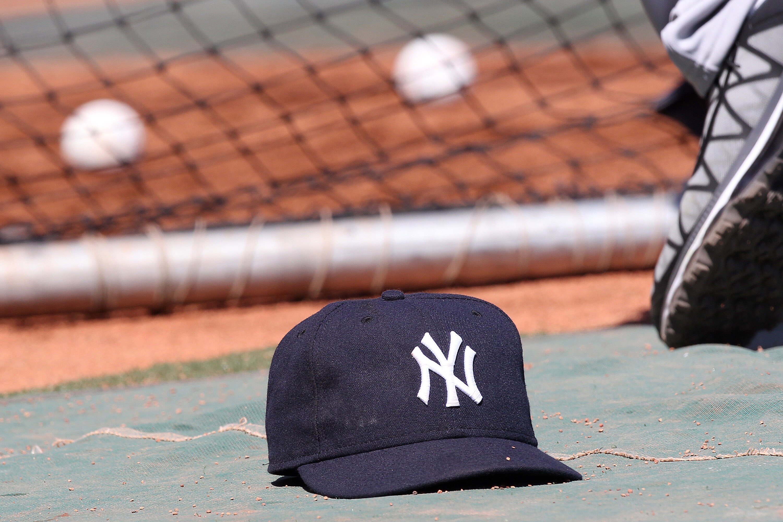 BOSTON, MA - APRIL 9:  The cap of Jorge Posada #20 of the New York Yankees rests on the ground during batting practice before a game against the Boston Red Sox at Fenway Park April 9, 2011 in Boston, Massachusetts. (Photo by Jim Rogash/Getty Images)