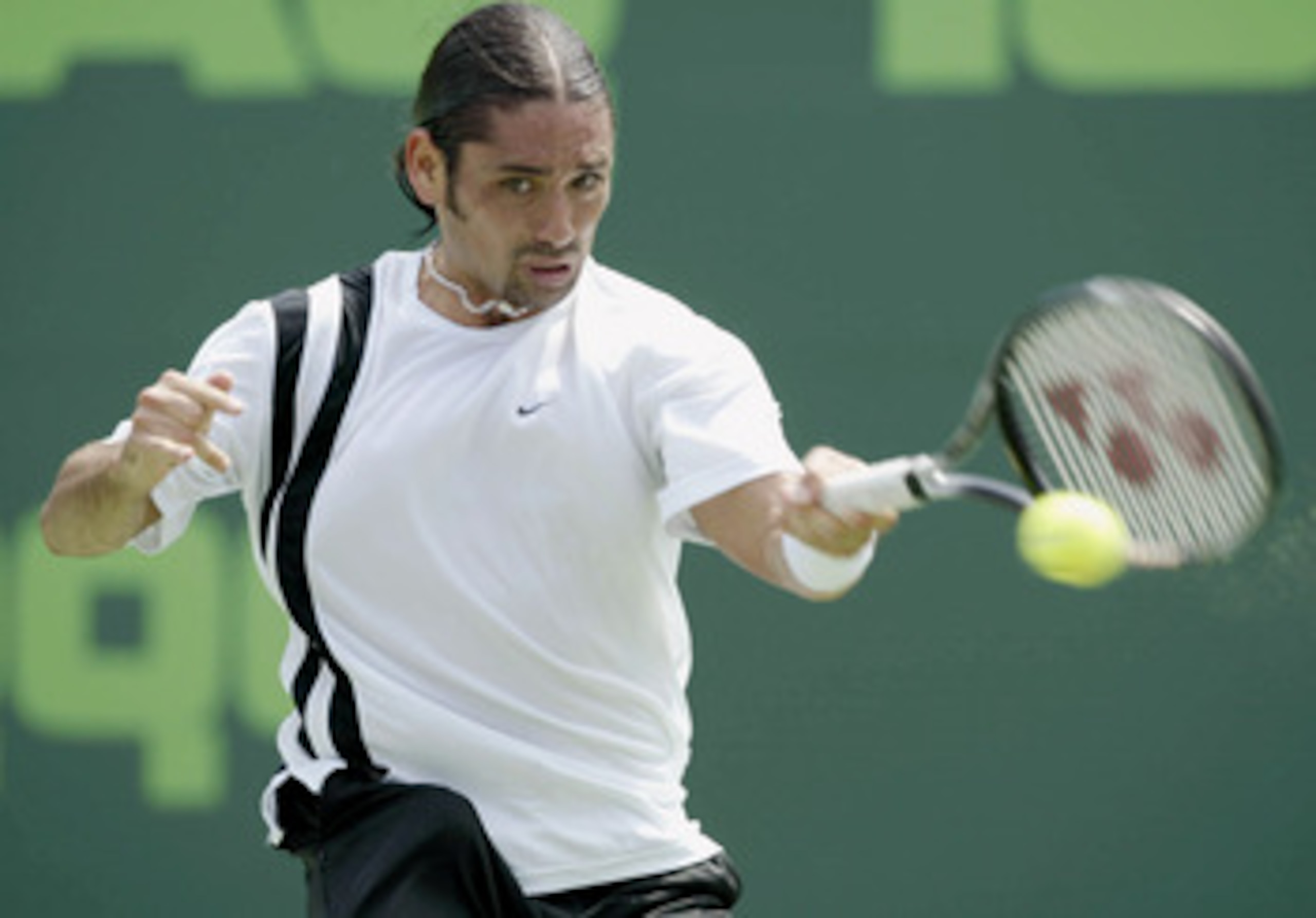 MIAMI - MARCH 23: Marcelo Rios of Chile returns a shot to Juan Carlos Ferrero of Spain during the Nasdaq-100 Open March 23, 2003 at the Tennis Center at Crandon Park in Miami, Florida. (Photo by Andy Lyons/Getty Images) MIAMI - MARCH 23: Marcelo Rios of Chile returns a shot to Juan Carlos Ferrero of Spain during the Nasdaq-100 Open March 23, 2003 at the Tennis Center at Crandon Park in Miami, Florida. (Photo by Andy Lyons/Getty Images)