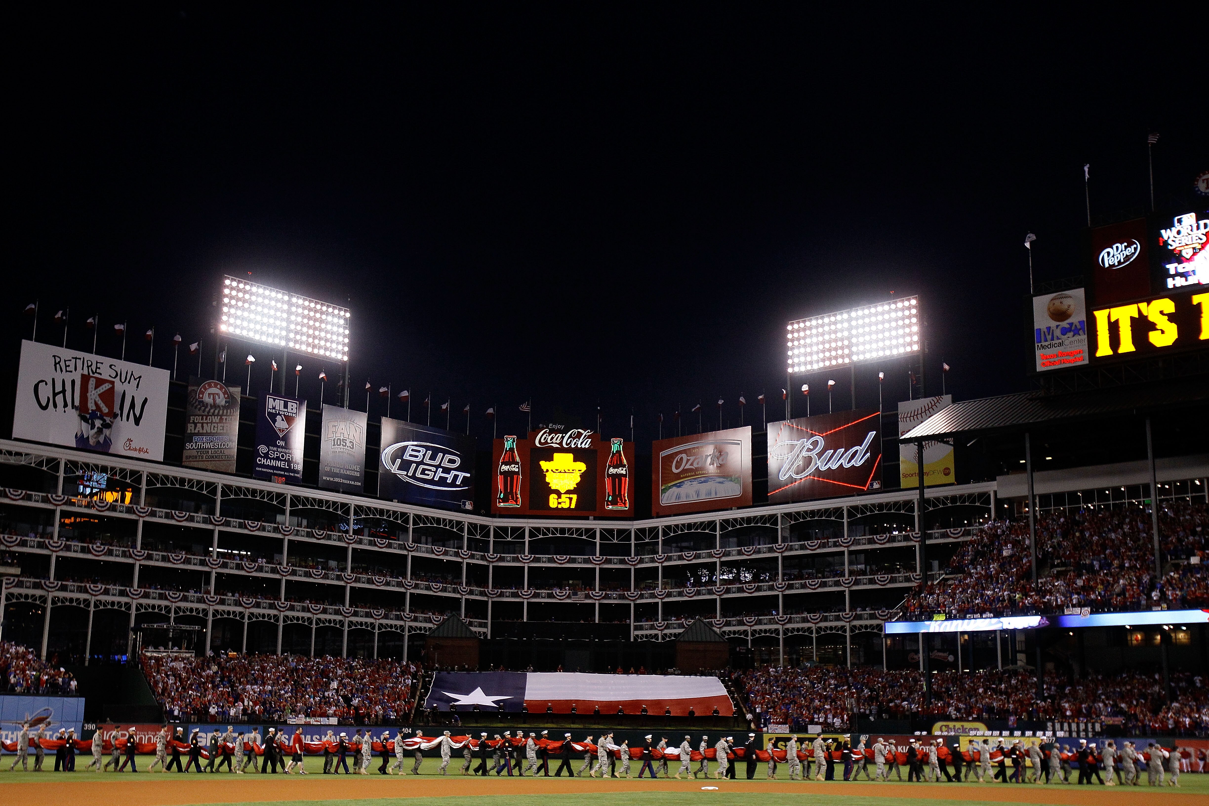 ARLINGTON, TX - OCTOBER 31:  Military personnel carry a giant American Flag on to the field for the performance of the National Anthem prior to the Texas Rangers playing against the San Francisco Giants in Game Four of the 2010 MLB World Series at Rangers