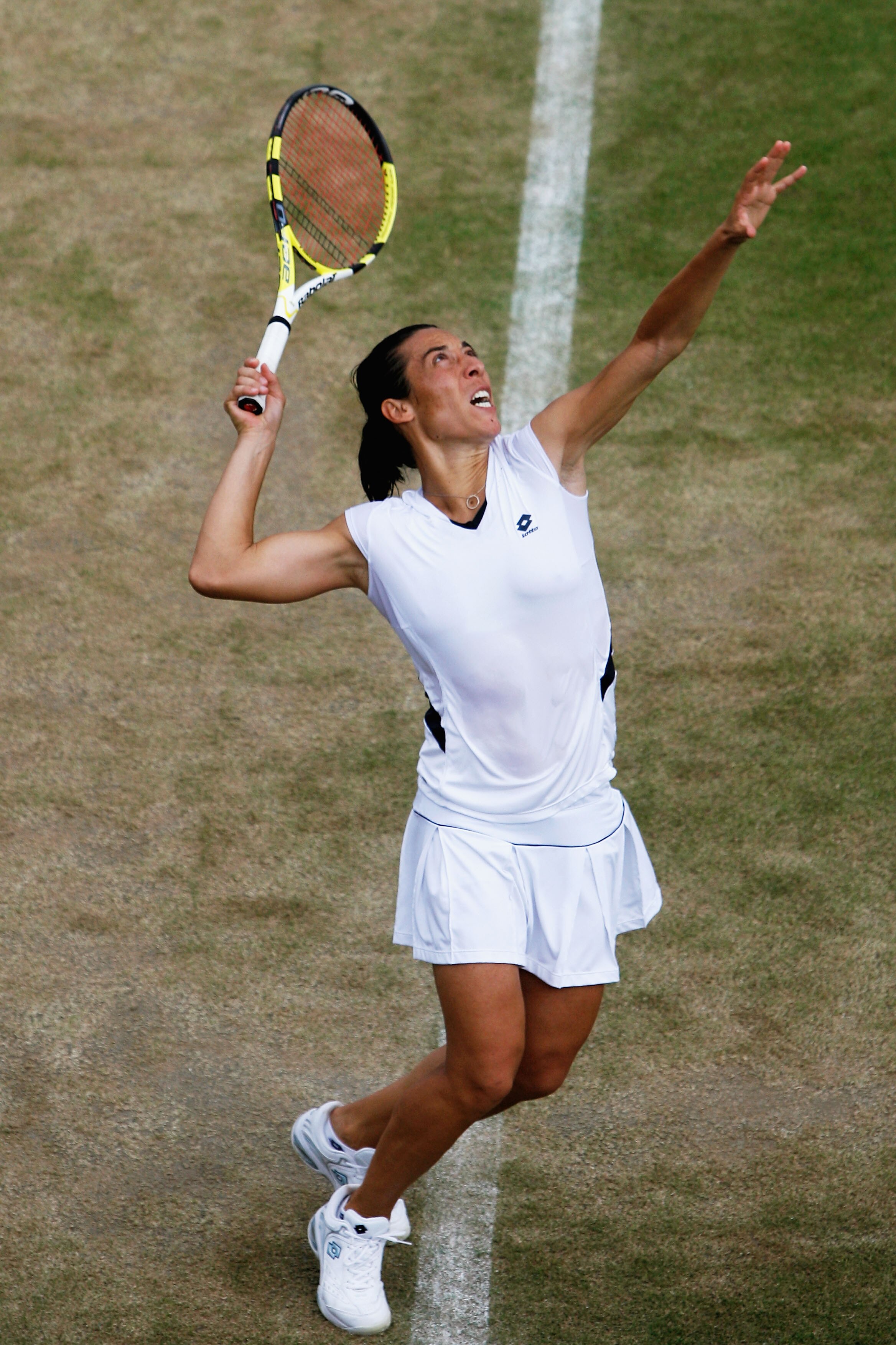 WIMBLEDON, ENGLAND - JUNE 29:  Francesca Schiavone of Italy serves during the women's singles fourth round match against Virginie Razzano of France on Day Seven of the Wimbledon Lawn Tennis Championships at the All England Lawn Tennis and Croquet Club on