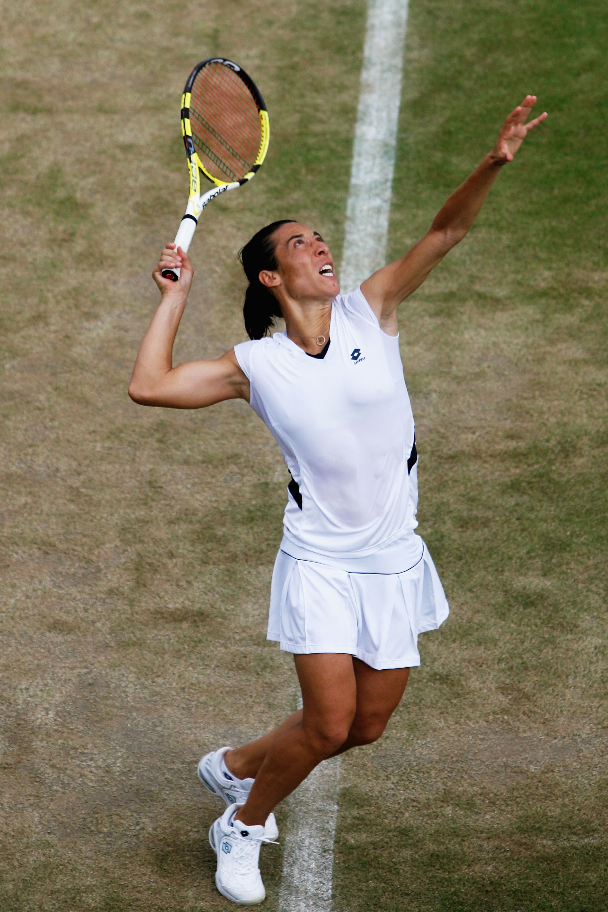 WIMBLEDON, ENGLAND - JUNE 29:  Francesca Schiavone of Italy serves during the women's singles fourth round match against Virginie Razzano of France on Day Seven of the Wimbledon Lawn Tennis Championships at the All England Lawn Tennis and Croquet Club on