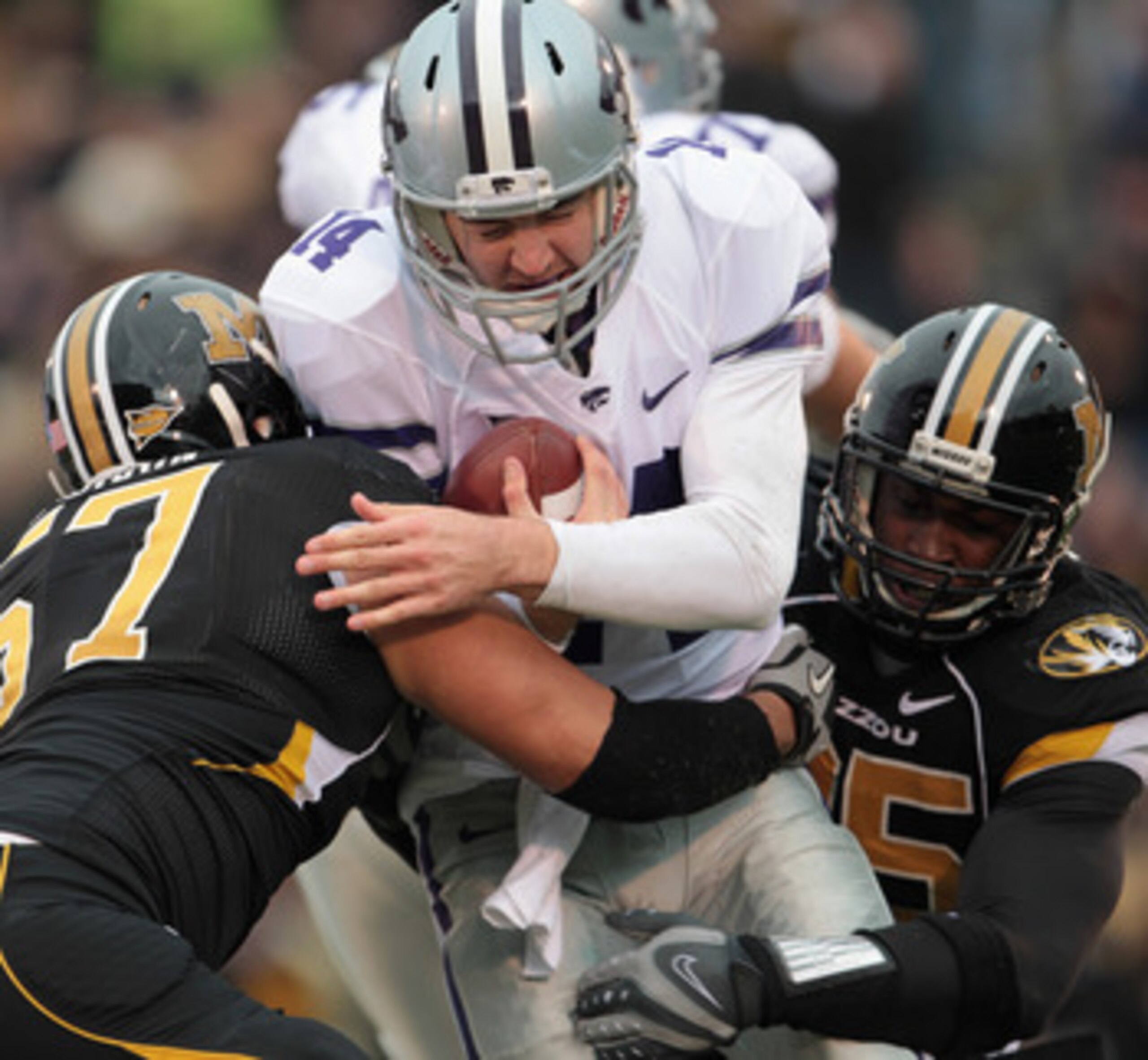 COLUMBIA, MO - NOVEMBER 13:  Quarterback Carson Coffman #14 of the Kansas State Wildcats is sacked by Brad Madison #57 and Aldon Smith #85 of the Missouri Tigers during the game on November 13, 2010 at Faurot Field/Memorial Stadium in Columbia, Missouri.
