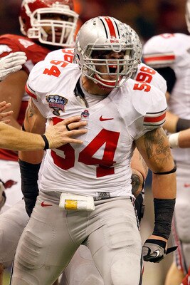 NEW ORLEANS, LA - JANUARY 04:  John Simon #54 of the Ohio State Buckeyes reacts after hitting quarterback Ryan Mallett #15 of the Arkansas Razorbacks in the second quarter during the Allstate Sugar Bowl at the Louisiana Superdome on January 4, 2011 in New