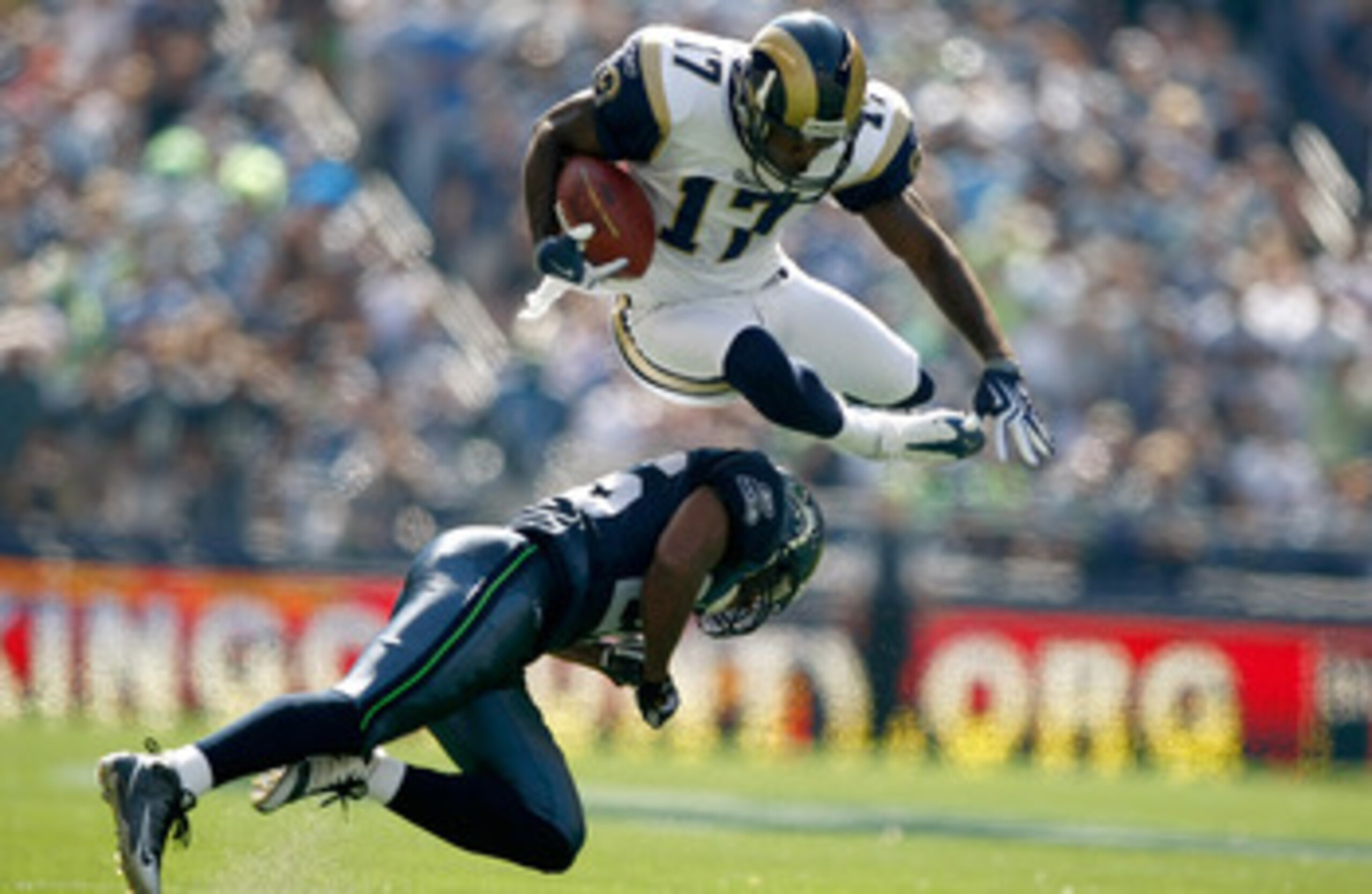 SEATTLE , WA - SEPTEMBER 13:  Donnie Avery #17 of the St. Louis Rams leaps over Josh Wilson #26 of the Seattle Seahawks at Qwest Field on September 13, 2009 in Seattle, Washington.  (Photo by Jonathan Ferrey/Getty Images)