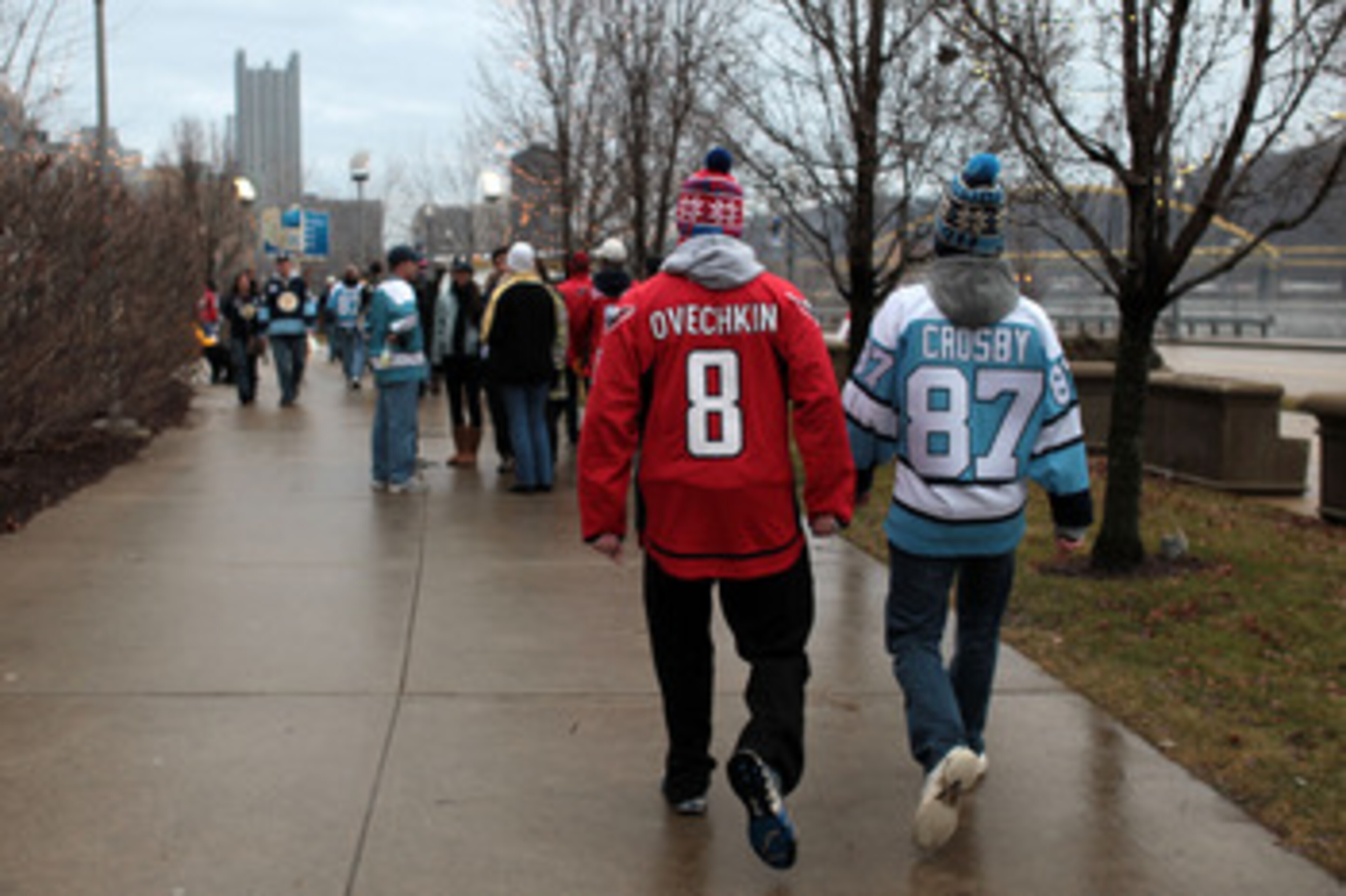 PITTSBURGH, PA - JANUARY 01:  A fan of the Washington Captials wears an 'Ovechkin' jersey while walking alongside a fan of the Pittsburgh Penguins wearing a 'Crosby' jersey prior to the start of the 2011 NHL Bridgestone Winter Classic at Heinz Field on Ja