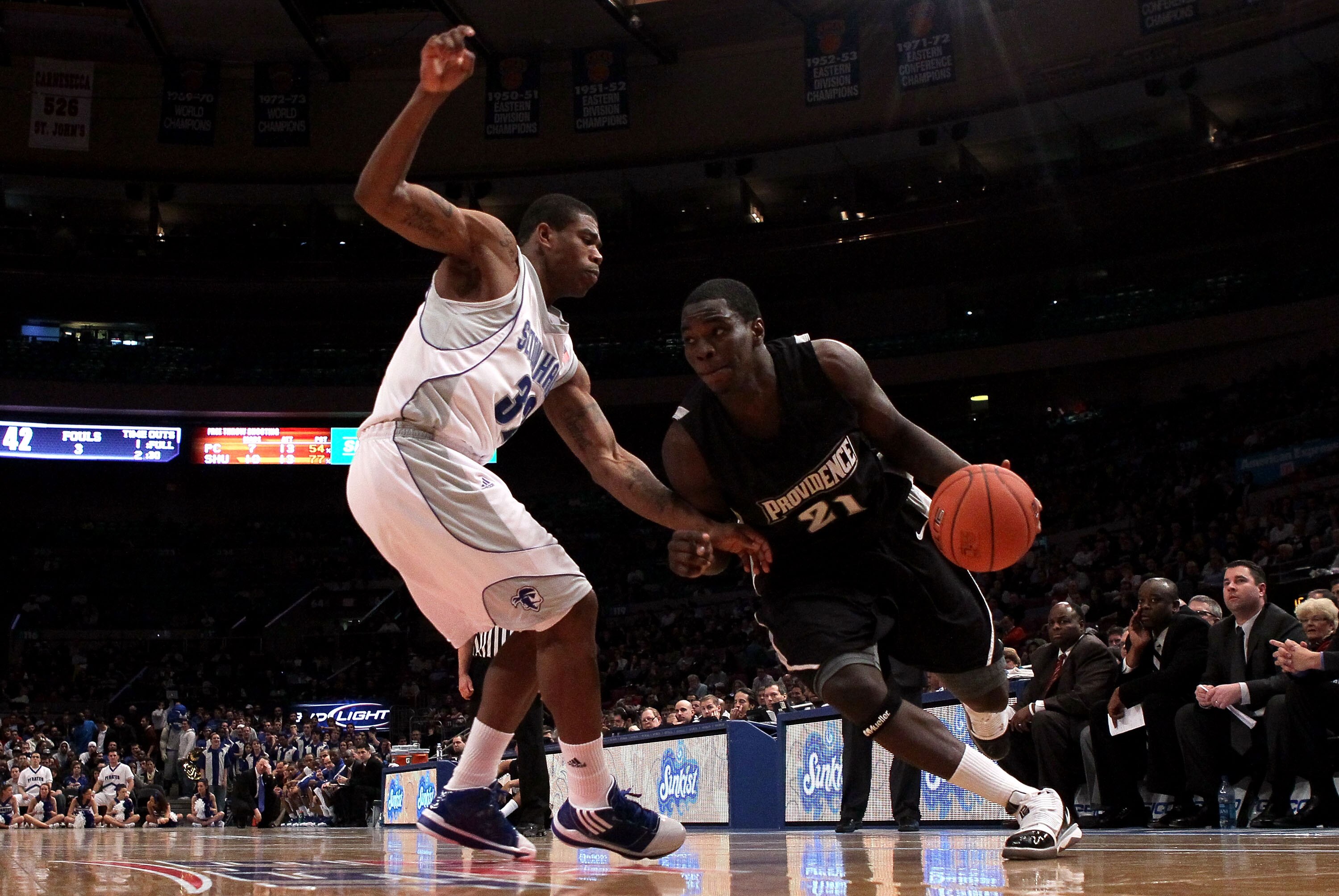 NEW YORK - MARCH 09:  Jamine Peterson #21 of the Providence Friars drives to the hoop against Jeff Robinson #32 of the Seton Hall Pirates during the first round game of the Big East Basketball Tournament at Madison Square Garden on March 9, 2010 in New Yo