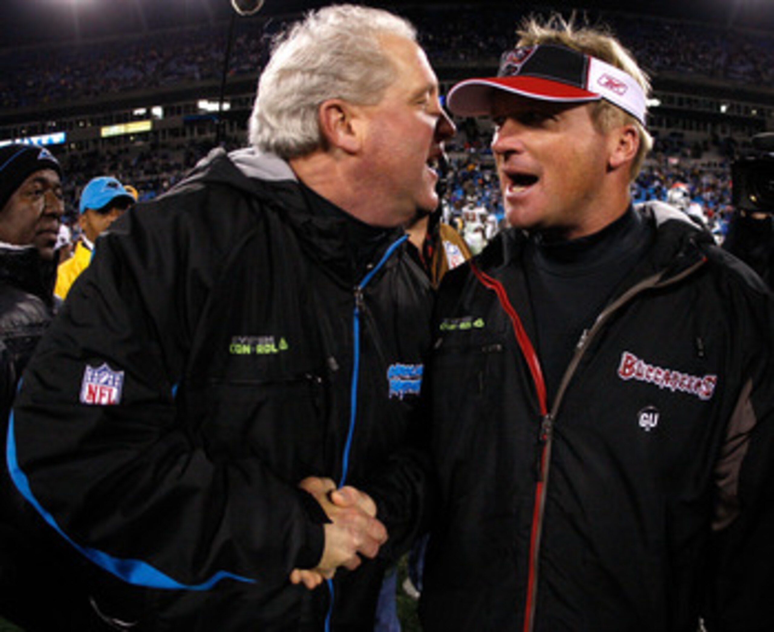 CHARLOTTE, NC - DECEMBER 08:  Head coach Jon Gruden (R) of the Tampa Bay Buccaneers shakes hands with head coach John Fox (L) of the Carolina Panthers after the game at Bank of America Stadium on December 8, 2008 in Charlotte, North Carolina.  (Photo by S