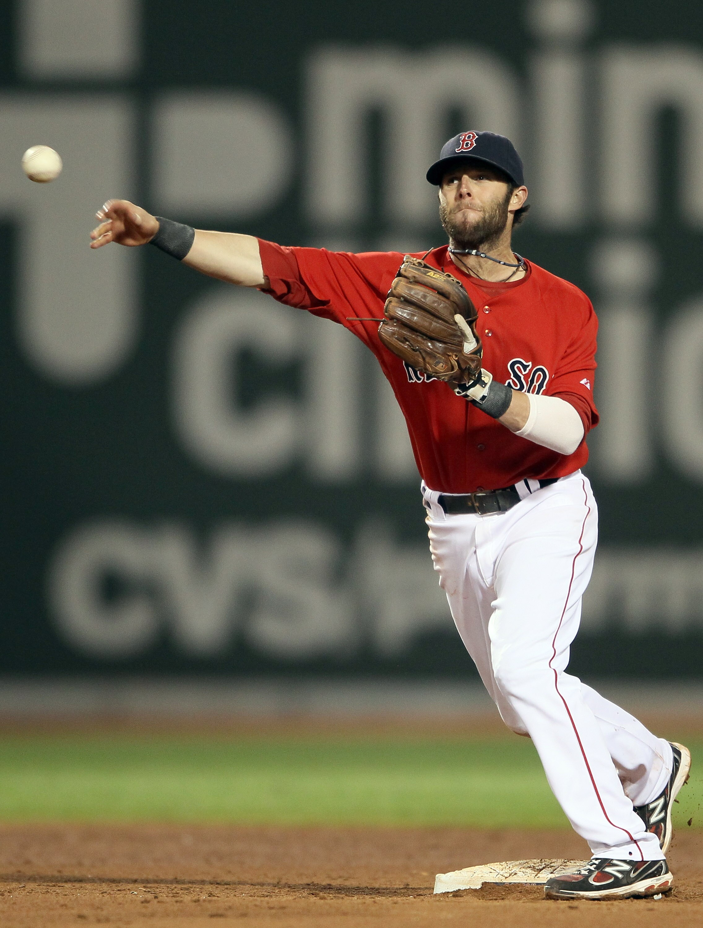 BOSTON, MA - JUNE 03:  Dustin Pedroia #15 of the Boston Red Sox turns the double play in the seventh inning against the Oakland Athletics on June 3, 2011 at Fenway Park in Boston, Massachusetts.  (Photo by Elsa/Getty Images)