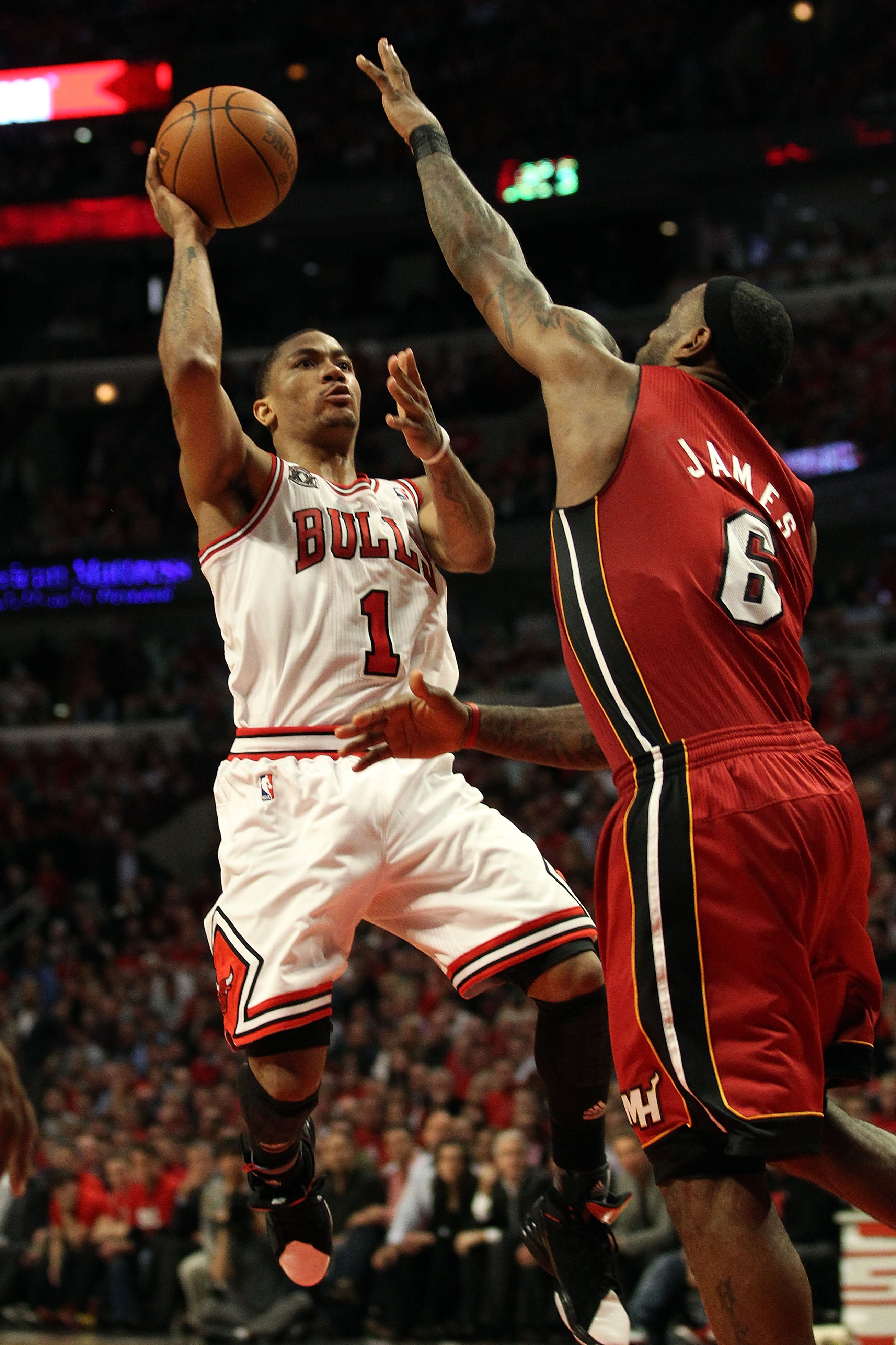 CHICAGO, IL - MAY 26:  Derrick Rose #1 of the Chicago Bulls drives for a shot attempt against LeBron James #6 of the Miami Heat in Game Five of the Eastern Conference Finals during the 2011 NBA Playoffs on May 26, 2011 at the United Center in Chicago, Ill