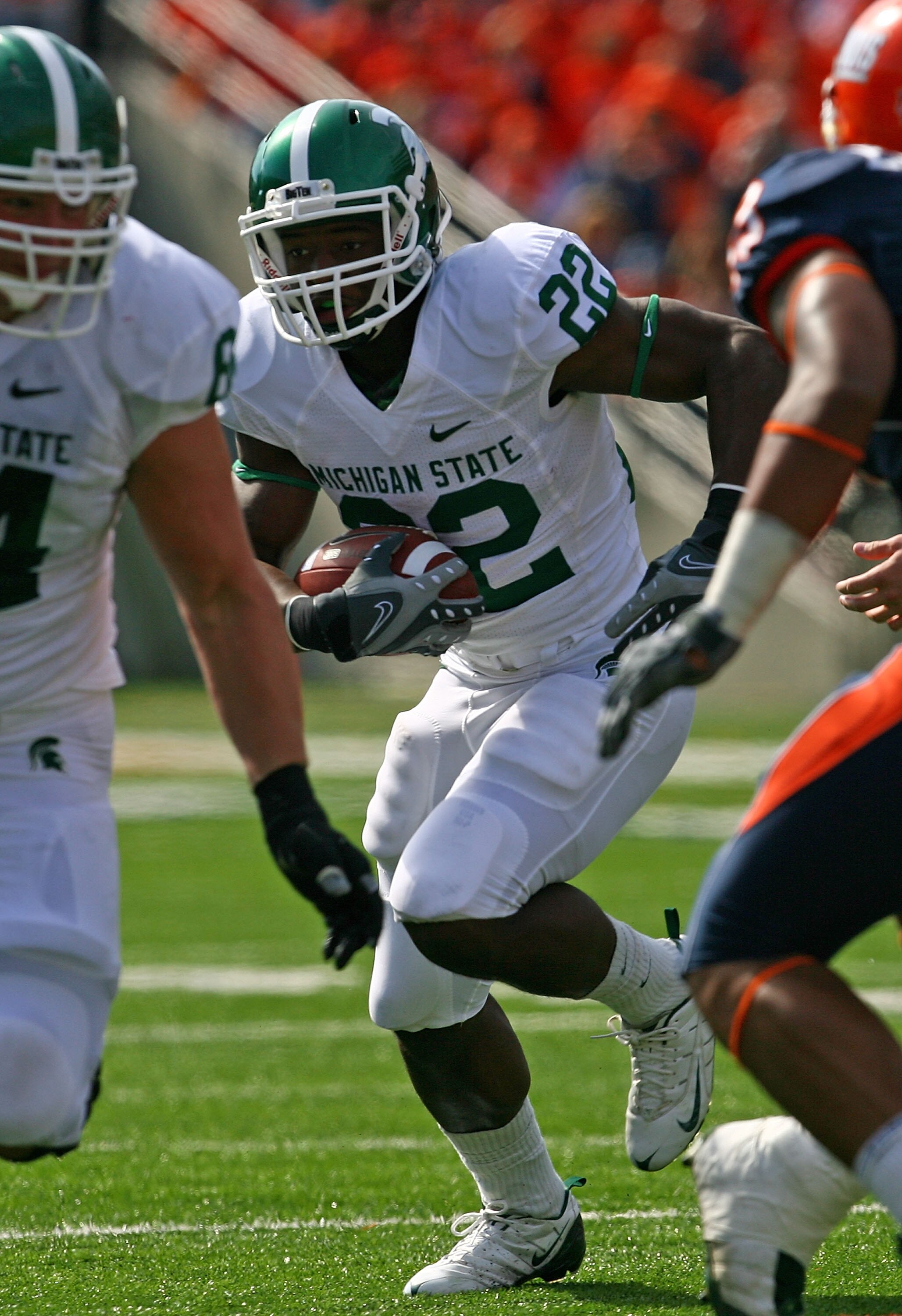 CHAMPAIGN, IL - OCTOBER 10: Larry Caper #22 of the Michigan State Spartans runs for a touchdown against the Illinois Fighting Illini on October 10, 2009 at Memorial Stadium at the University of Illinois in Champaign, Illinois. Michigan State defeated Illi