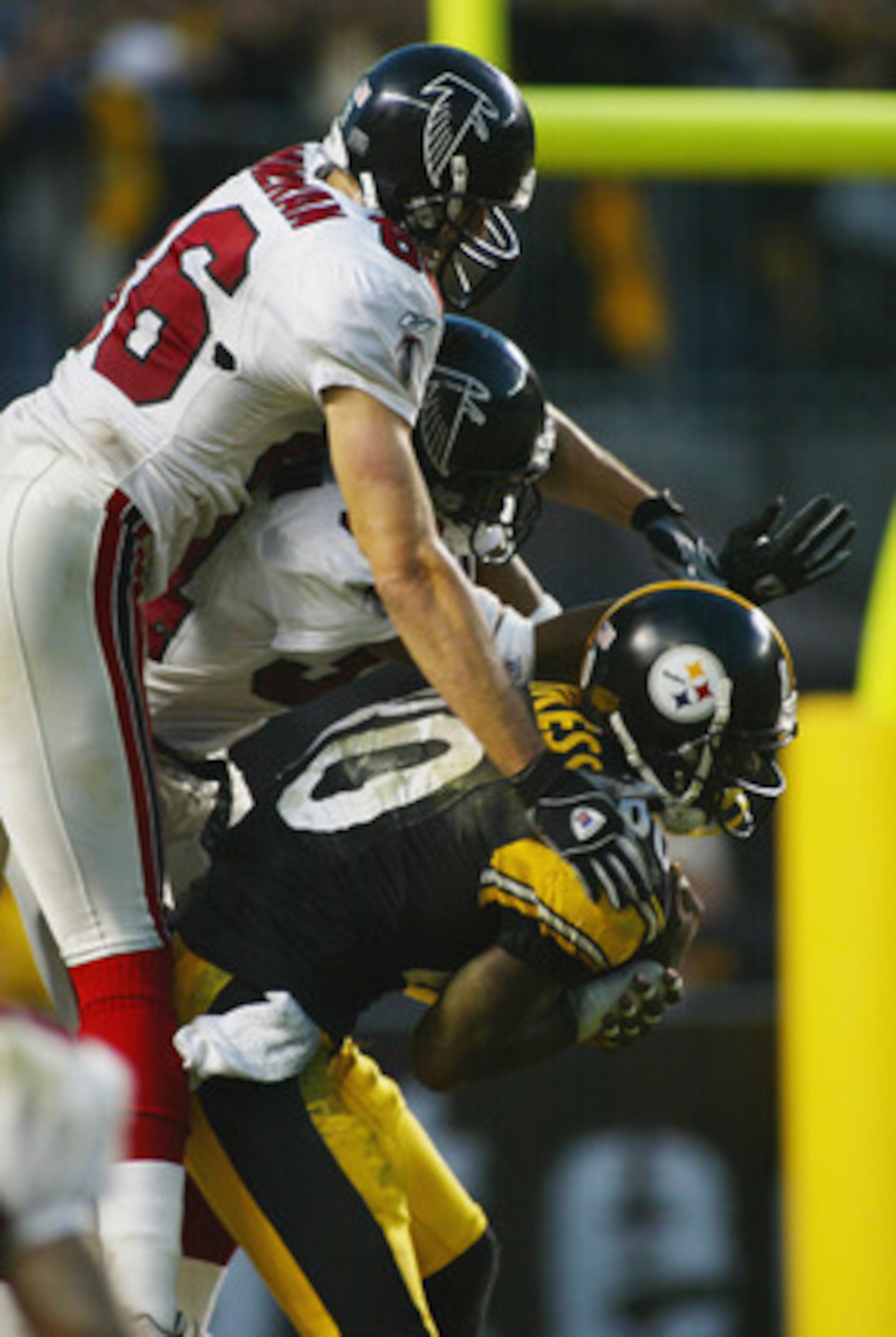 PITTSBURGH, PA - NOVEMBER 10:  Plaxico Burress #80 of the Pittsburgh Steelers is stopped at the one yard line on the last play of the game by Brian Finneran #86 and Ray Buchanan #34 of the Atlanta Falcons during the NFL game at Heinz Field on November 10,