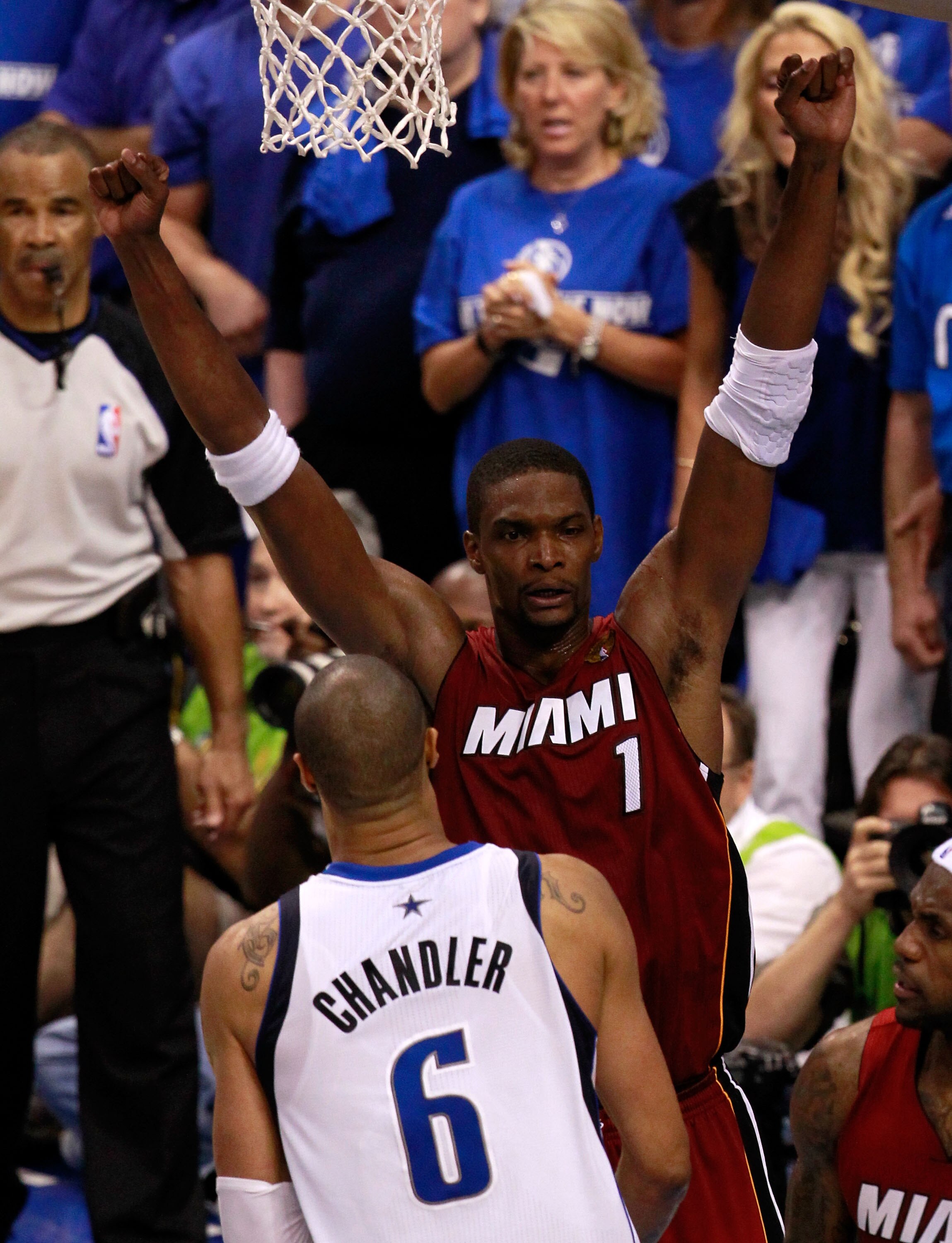 DALLAS, TX - JUNE 05:  Chris Bosh #1 of the Miami Heat celebrates against Tyson Chandler #6 of the Dallas Mavericks after the Heat won 88-86 in Game Three of the 2011 NBA Finals at American Airlines Center on June 5, 2011 in Dallas, Texas.  NOTE TO USER: