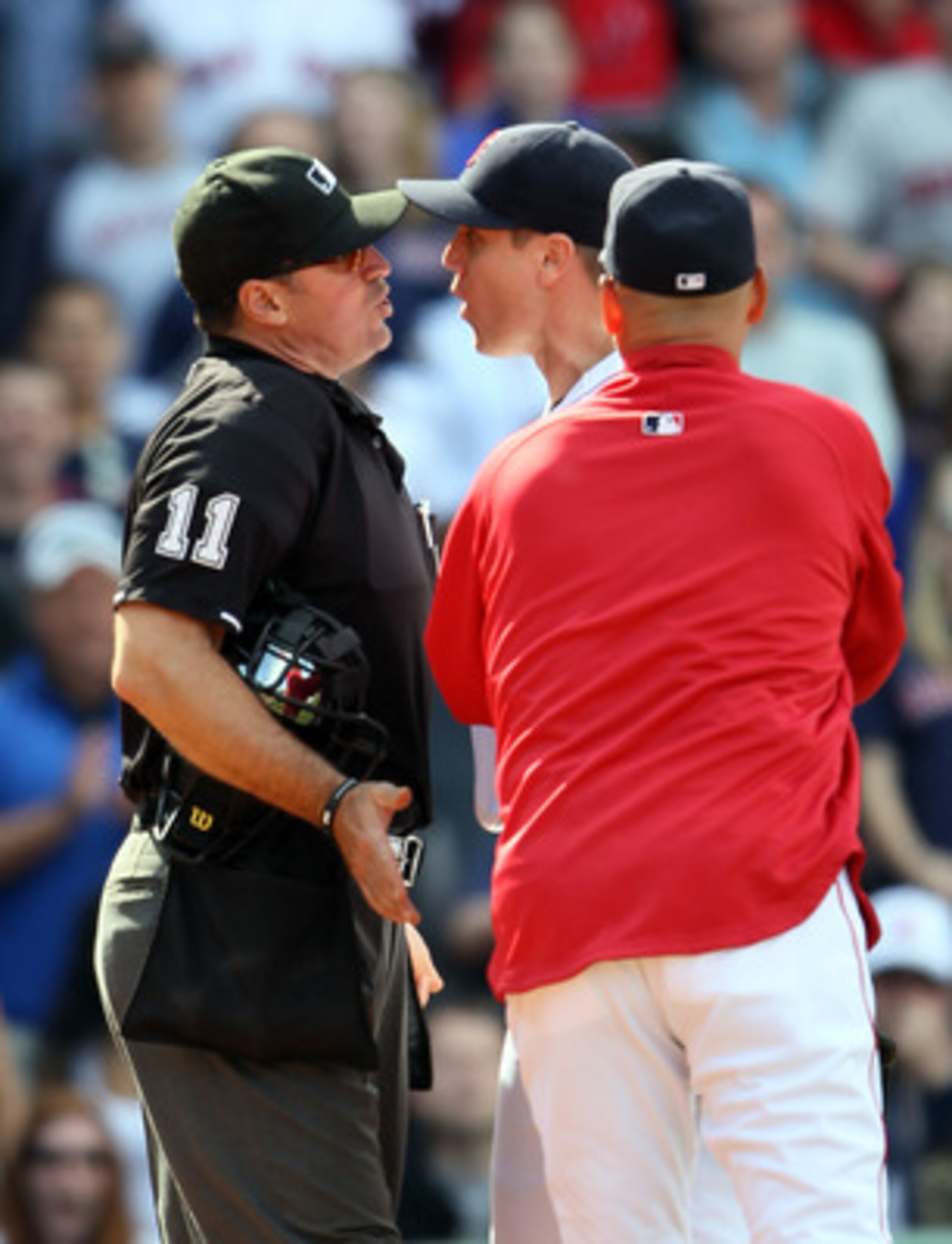 BOSTON, MA - JUNE 04:  Jonathan Papelbon #58 of the Boston Red Sox and home plate umpire Tony Randazzo #11 are separated by manager Terry Francona #47 of the Red Sox in the bottom of the ninth inning against the Oakland Athletics on June 4, 2011 at Fenway