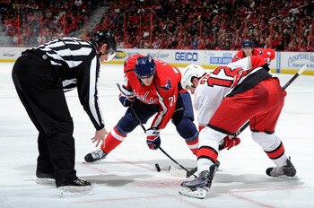 WASHINGTON - NOVEMBER 28:  Brooks Laich #21 of the Washington Capitals takes a face off against Eric Staal #12 of the Carolina Hurricanes at the Verizon Center on November 28, 2010 in Washington, DC.  (Photo by Greg Fiume/Getty Images)
