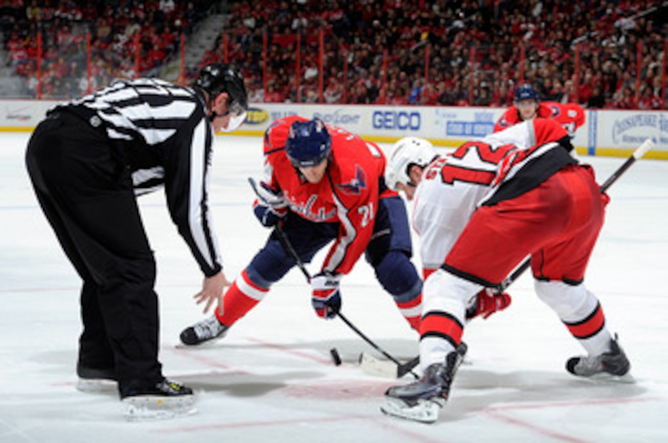 WASHINGTON - NOVEMBER 28:  Brooks Laich #21 of the Washington Capitals takes a face off against Eric Staal #12 of the Carolina Hurricanes at the Verizon Center on November 28, 2010 in Washington, DC.  (Photo by Greg Fiume/Getty Images)