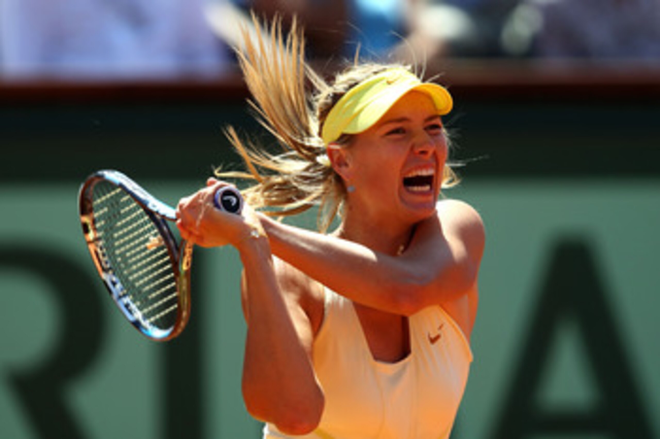 PARIS, FRANCE - JUNE 02:  Maria Sharapova of Russia hits a backhand during the women's singles semi final match between Na Li of China and Maria Sharapova of Russia on day twelve of the French Open at Roland Garros on June 2, 2011 in Paris, France.  (Phot