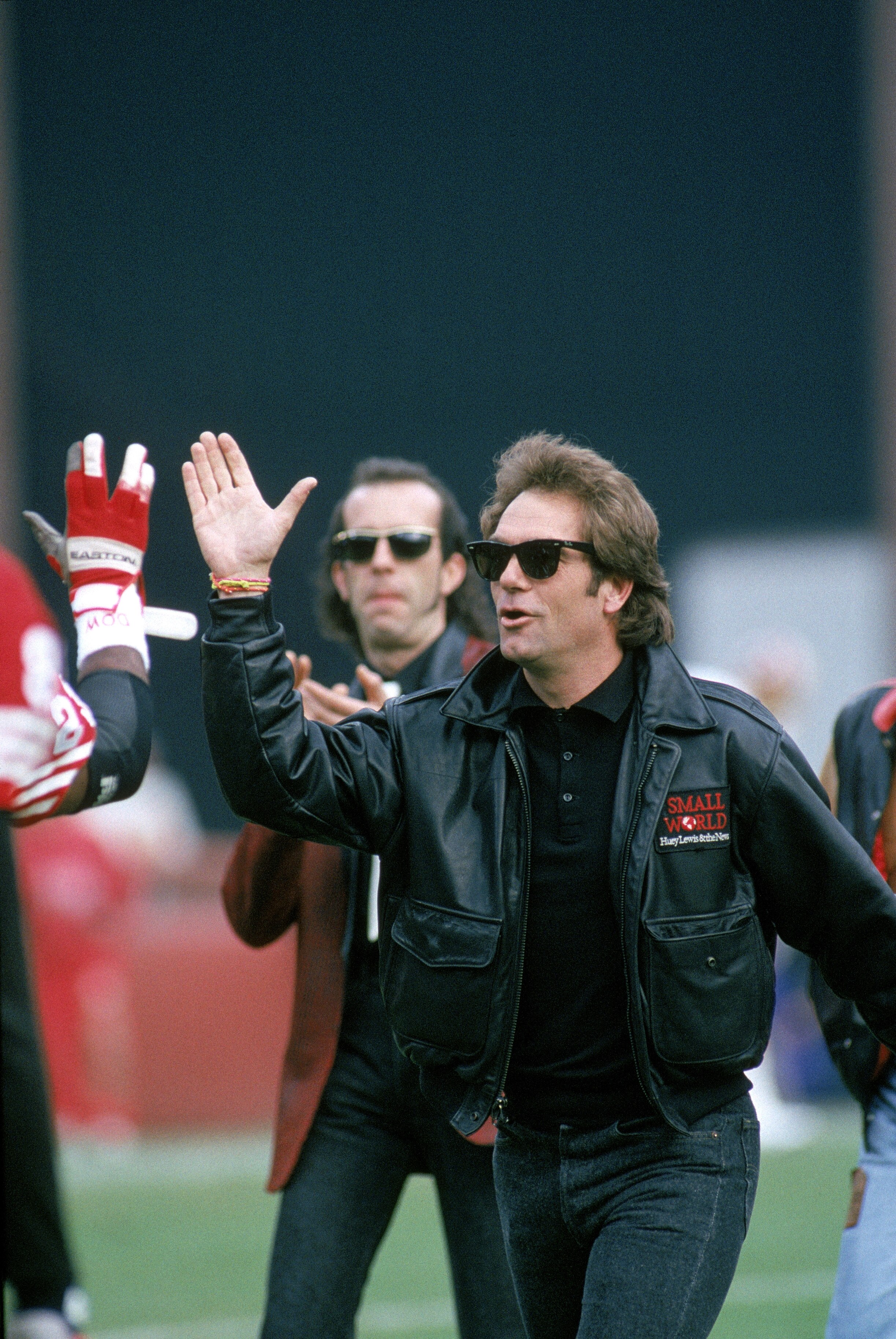 SAN FRANCISCO - JANUARY 20:  Huey Lewis & the News perform the National Anthem before a game with the New York Giants taking on the San Francisco 49ers for the 1990 National Football Conference Division Playoffs at 3Com Park on January 12, 1991 in San Fra