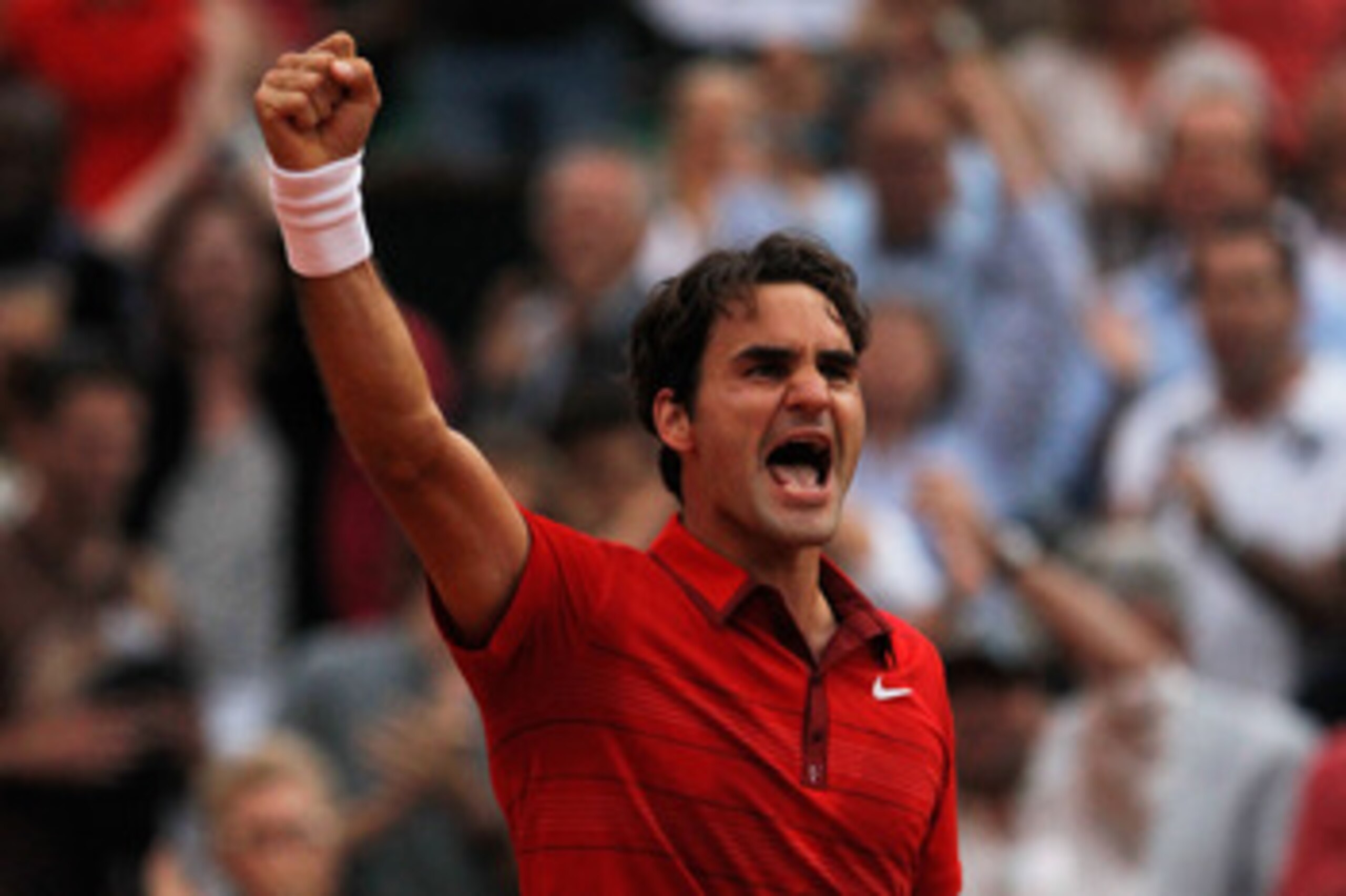 PARIS, FRANCE - JUNE 03:  Roger Federer of Switzerland celebrates match point during the men's singles semi final match between Roger Federer of Switzerland and Novak Djokovic of Serbia on day thirteen of the French Open at Roland Garros on June 3, 2011 i