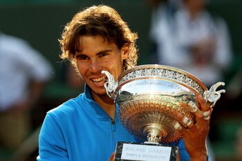 PARIS, FRANCE - JUNE 05:  Champion Rafael Nadal of Spain bites the trophy following his record equalling sixth victory during the men's singles final match between Rafael Nadal of Spain and Roger Federer of Switzerland on day fifteen of the French Open at