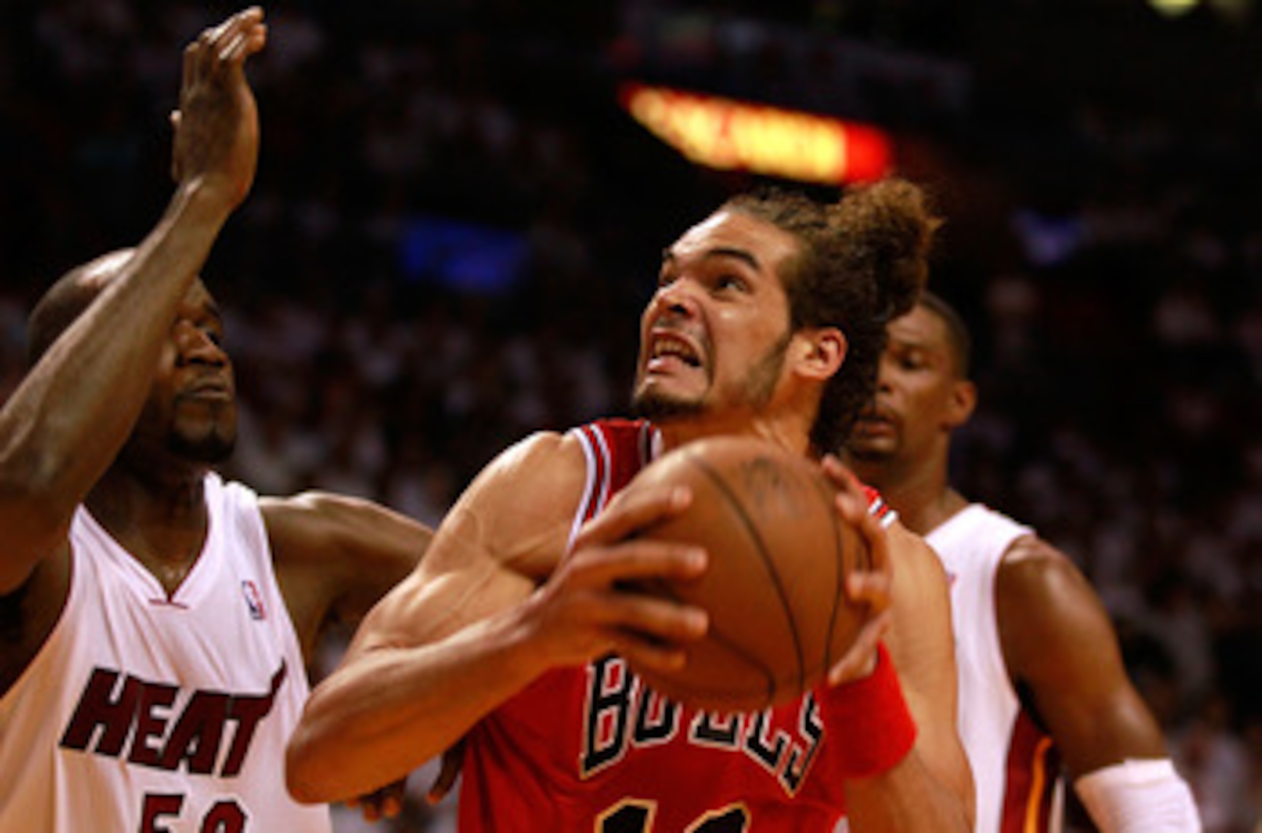 MIAMI, FL - MAY 24:  Joakim Noah #13 of the Chicago Bulls moves the ball inside against Joel Anthony #50 of the Miami Heat in Game Four of the Eastern Conference Finals during the 2011 NBA Playoffs on May 24, 2011 at American Airlines Arena in Miami, Flor