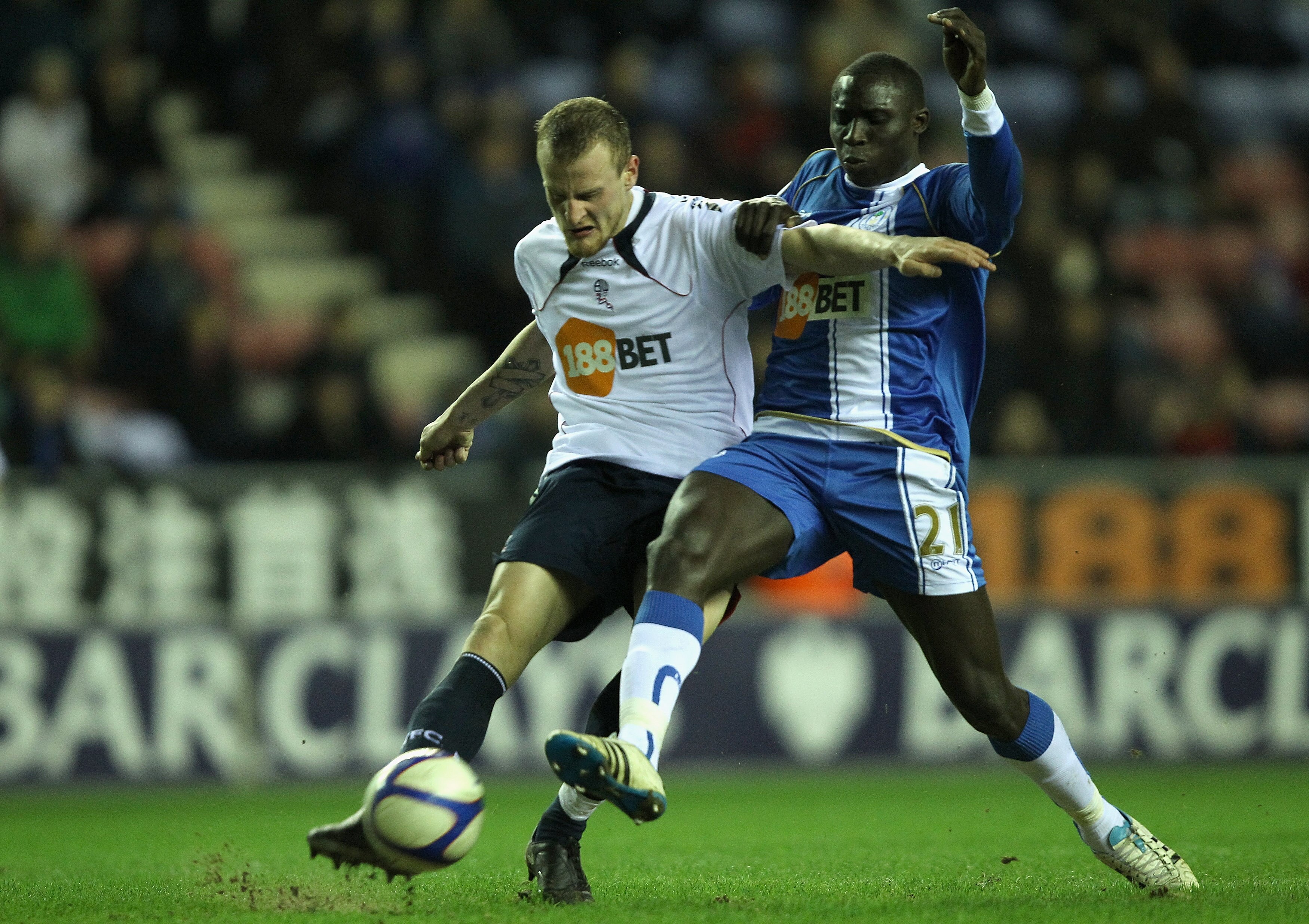 WIGAN, ENGLAND - FEBRUARY 16:  David Wheater of Bolton Wanderers attempts to clear from Mohamed Diame of Wigan Atheltic during the F.A Cup sponsored by E.ON 4th round replay match between Wigan Athletic and Bolton Wanderers at DW Stadium on February 16, 2