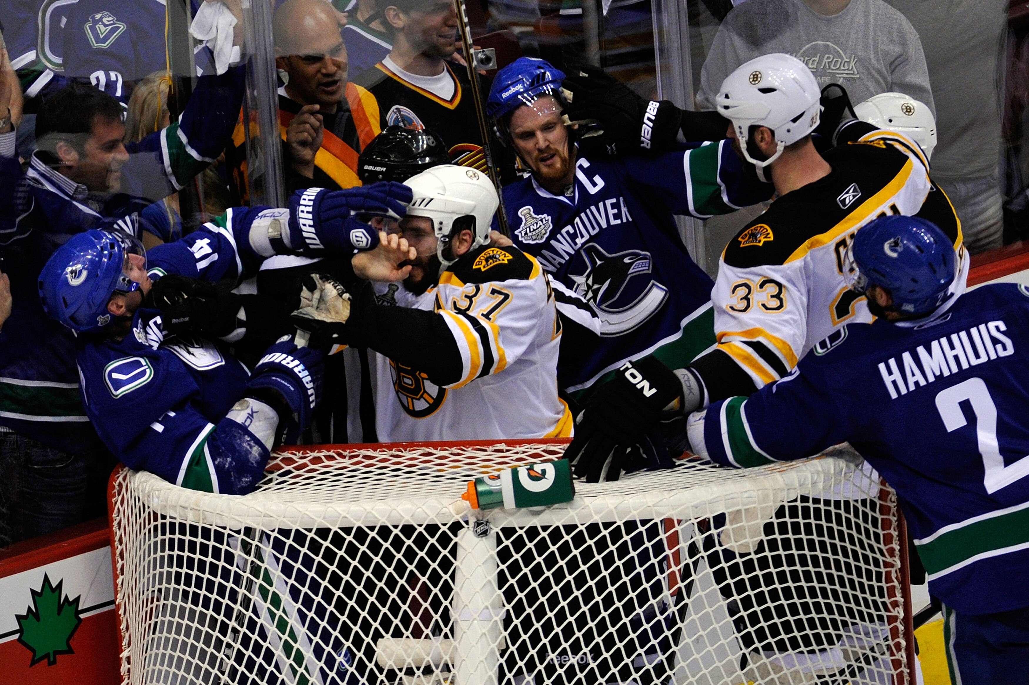 VANCOUVER, BC - JUNE 01:  Alex Burrows #14 of the Vancouver Canucks fights with Patrice Bergeron #37 of the Boston Bruins as Henrik Sedin #33 of the Vancouver Canucks and Zdeno Chara #33 of the Boston Bruins fight during game one of the 2011 NHL Stanley C