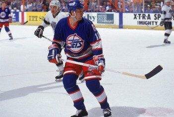 INGLEWOOD, CA - 1990:  Scott Arniel #11 of the Winnipeg Jets looks over his shoulder as he skates against the Los Angeles Kings during a game in the 1990-1991 NHL season at the Great Western Forum in Inglewood, California.  (Photo by Mike Powell/Getty Ima