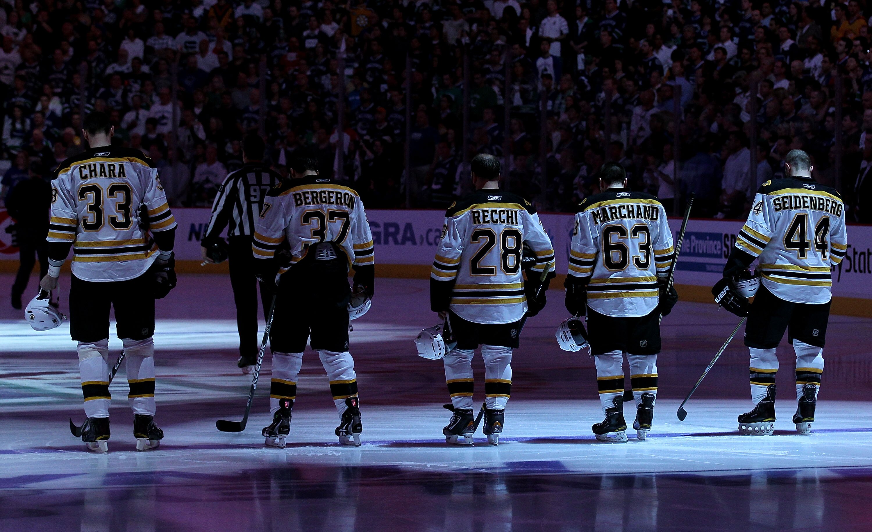 VANCOUVER, BC - JUNE 04:  (L-R) Zdeno Chara #33, Patrice Bergeron #37, Mark Recchi #28, Brad Marchand #63 and Dennis Seidenberg #44 of the Boston Bruins stand on the ice during Canada's national anthem prior to Game Two against the Vancouver Canucks in th