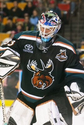 HAMILTON, CANADA - JANUARY 7:  Wade Flaherty #33 of the Manitoba Moose sweeps ice shavings from in front of the net against the Hamilton Bulldogs during the AHL game on January 7, 2006 at Copps Colliseum in Hamilton, Ontario, Canada.  The Bulldogs won 3-2