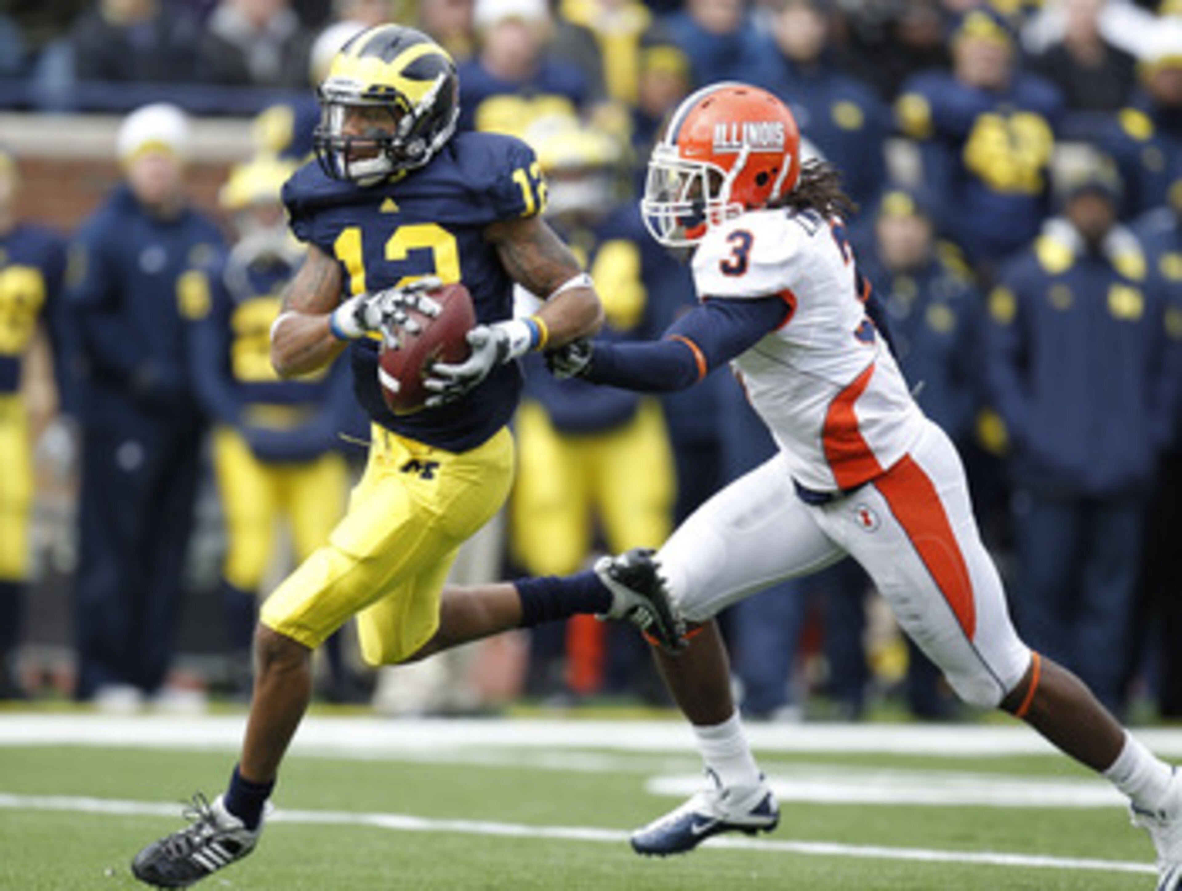 ANN ARBOR, MI - NOVEMBER 06:  Roy Roundtree #12 of the Michigan Wolverines gets past the tackle of Tavon Wilson #3 of the Illinios Fighting Illini after a second quarter reception at Michigan Stadium on November 6, 2010 in Ann Arbor, Michigan.  (Photo by 