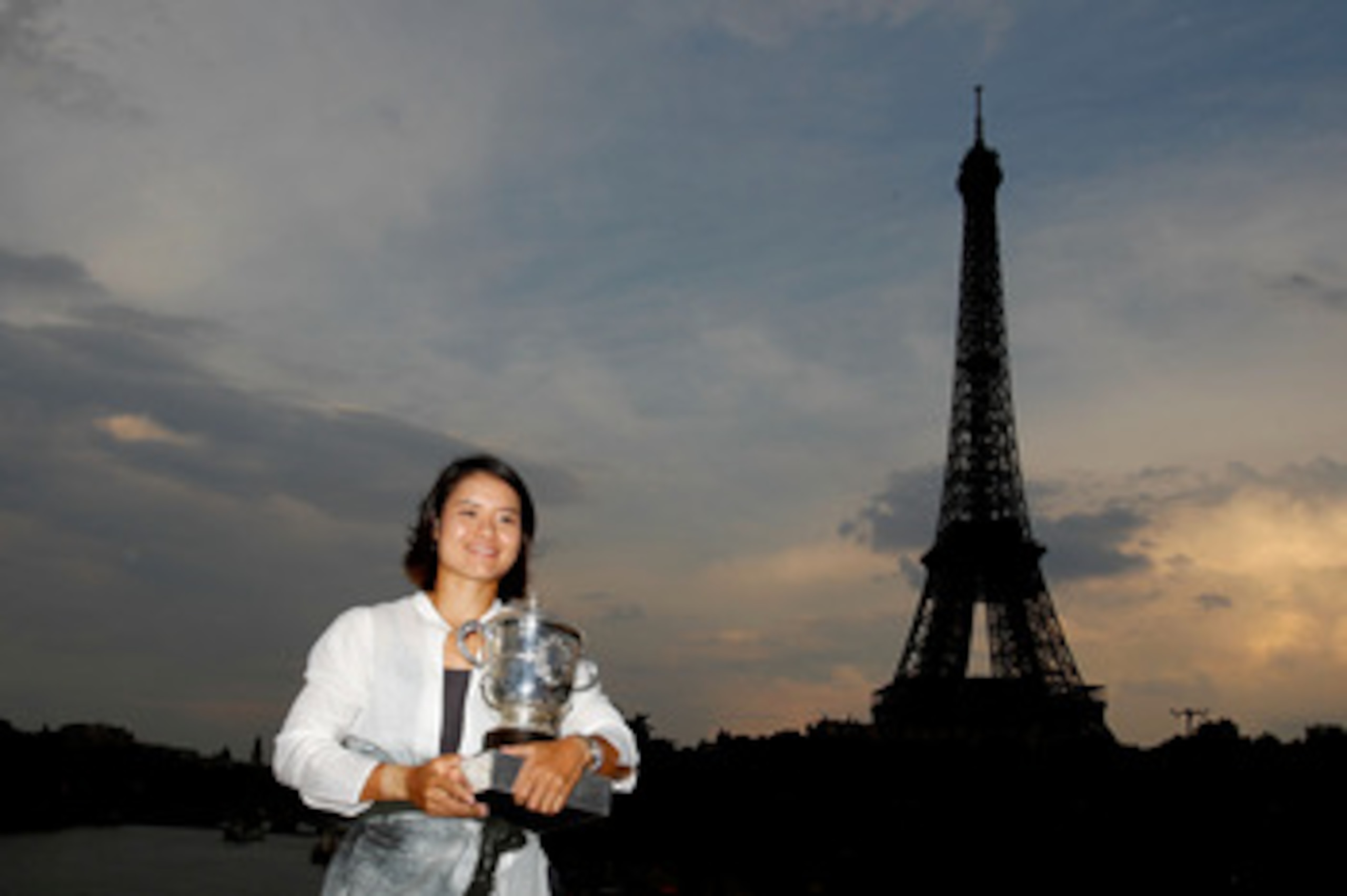 PARIS, FRANCE - JUNE 04:  Women's singles champion Na Li of China poses with the trophy by the banks of the River Seine on day fourteen of the French Open on June 4, 2011 in Paris, France.  (Photo by Matthew Stockman/Getty Images)