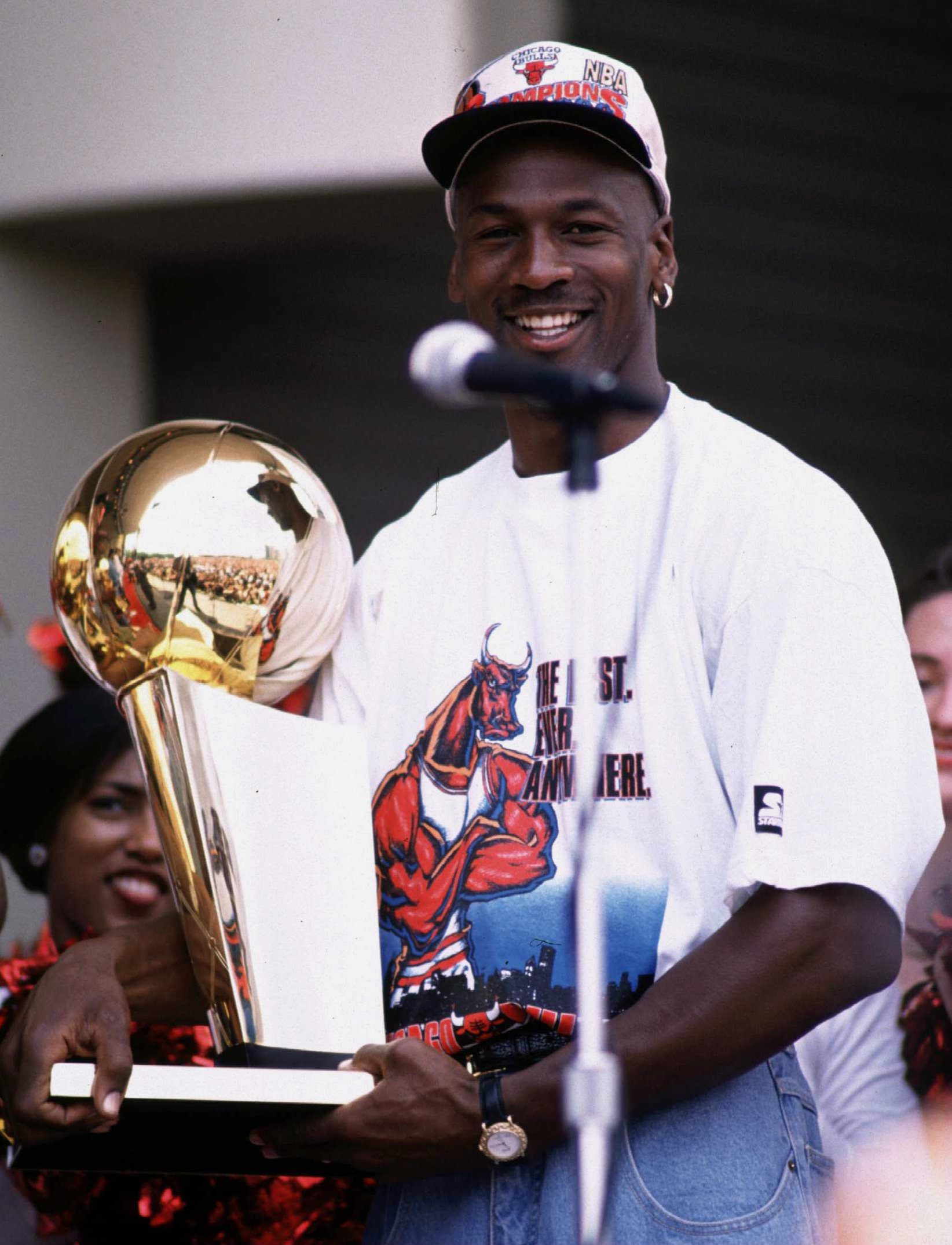 18 Jun 1996: Michael Jordan of the Chicago Bulls poses with the NBA championship trophy at the Bulls'' 1996 victory parade in Chicago, Illinois, after the Bulls won their 4th NBA championship in 6 years with a record of 83-13. Jordan, whose contract ends