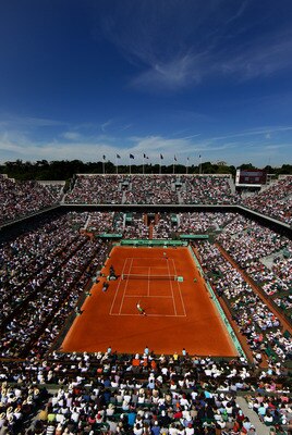 PARIS, FRANCE - MAY 28:  Gilles Simon of France serves in front of a packed Court Philippe Chatrier during the men's singles round three match between Mardy Fish of USA and Gilles Simon of France on day seven of the French Open at Roland Garros on May 28,
